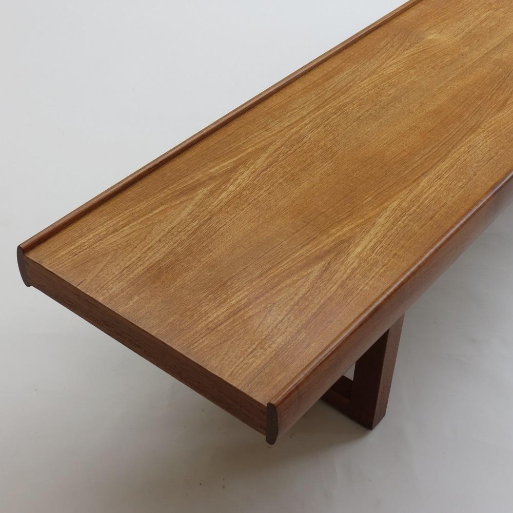 1960s Teak coffee table designed by Malcolm Walker for Dalescraft, UK.  Teak veneered top with solid Teak legs and wonderful finger joint detail to the legs.  Can be used as a coffee table or bench. Label to underside reads Dalescraft, Fine