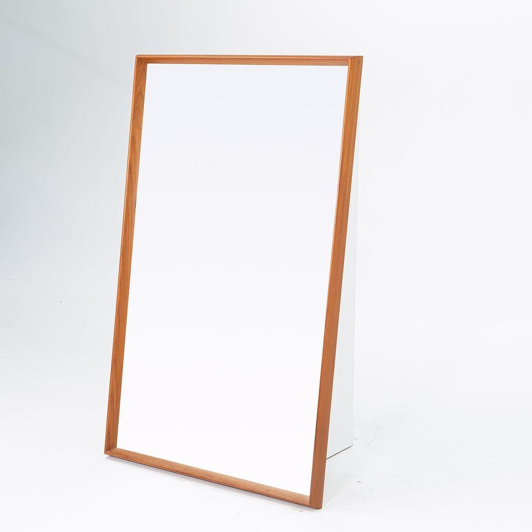 This is a large teak rectangular wall mirror, designed by Pedersen & Hansen for Viby J. in the early 1960s. The piece was hand made in Denmark 
 
 The mirror measures 21.5 inches wide, 1.75 inches deep, and 40.5 inches high. The mirror is In