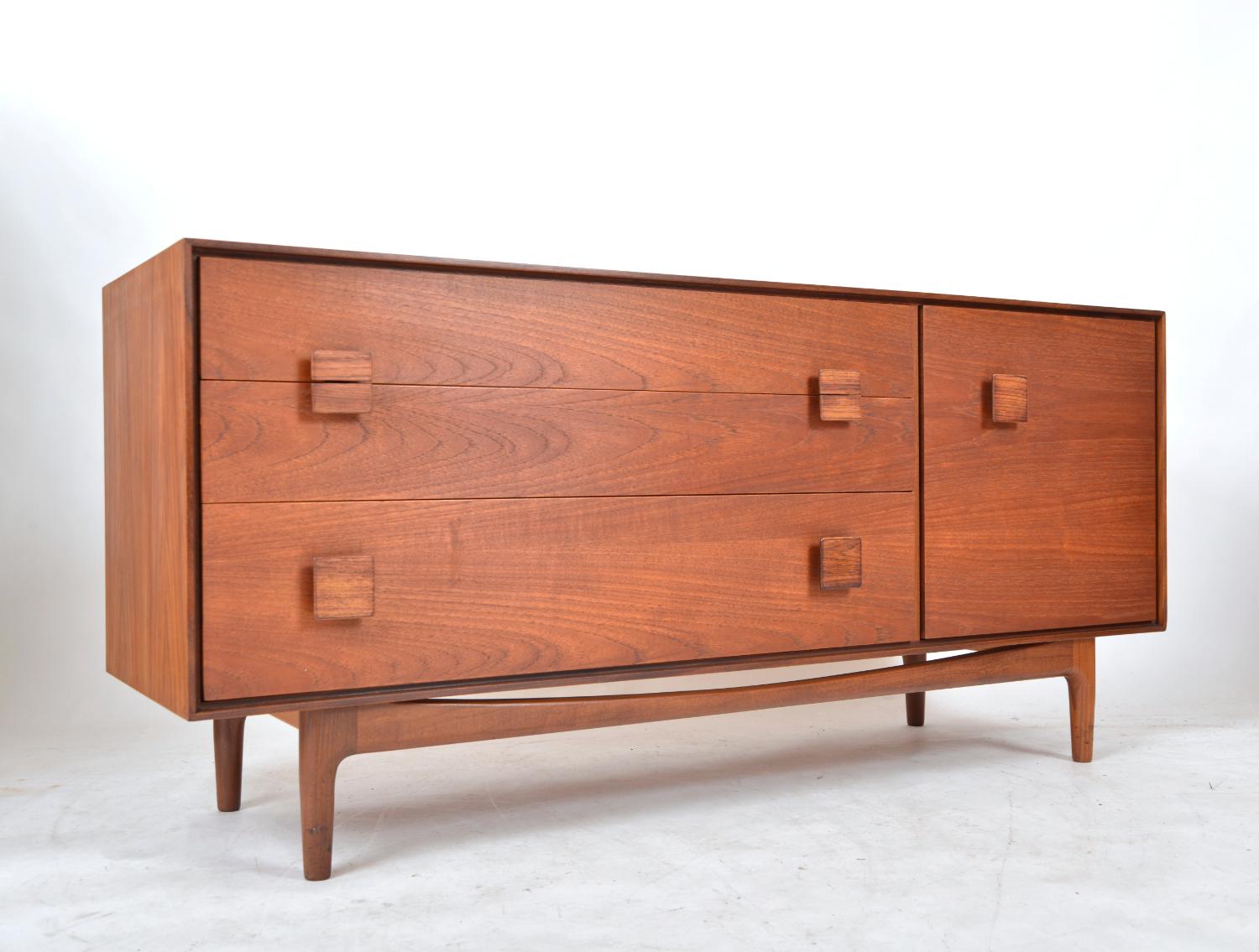 A stunning and rarely seen 1960s teak sideboard designed by the famous Danish designer Ib Kofod Larsen for G-Plan. The smallest of the sideboards he designed for G-Plan, but still featuring all of his stylish design touches synonymous with his