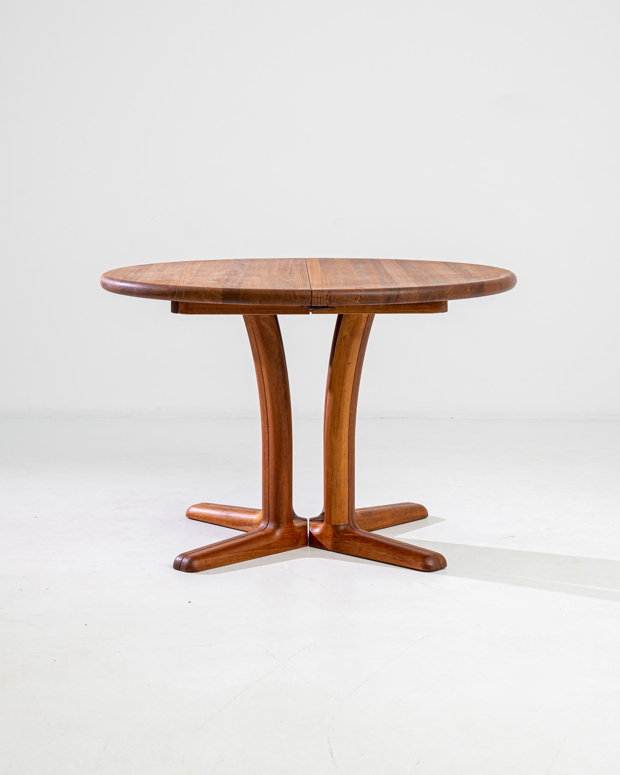 The Mid Century silhouette makes this circular teak table a delightful find. Made by Danish furniture manufacturers Gudme Mobelfabrik in the 1960s, the design combines sleek lines with an air of joyful levity in typical Scandinavian Modernist