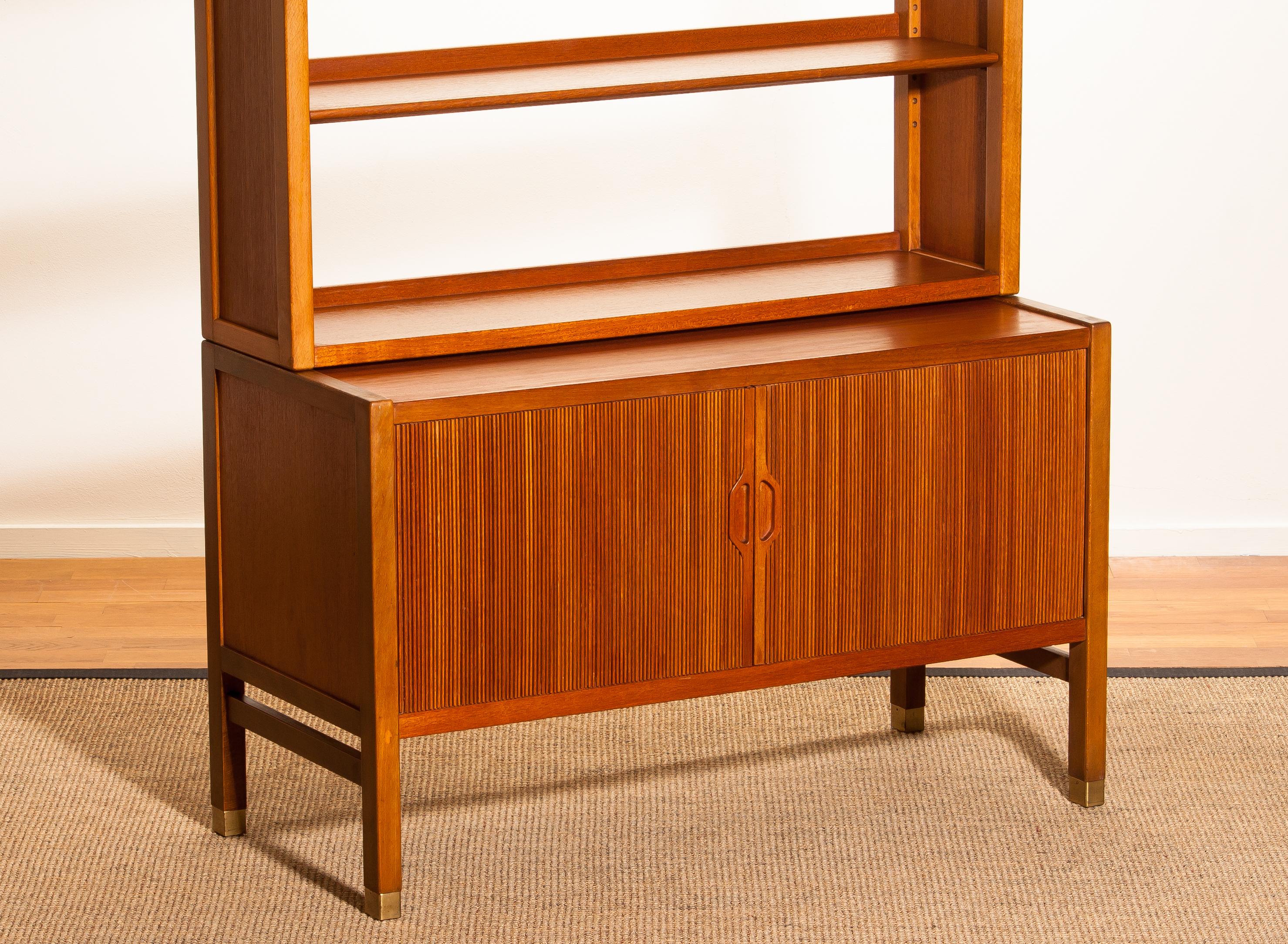 Very beautiful and elegant teak cabinet with tambour doors by Carl-Axel Acking for Bodafors, Sweden.
The lower part of the cabinet has two tambour doors and inside an adjustable shelf. The top part has two adjustable shelves. All in perfect