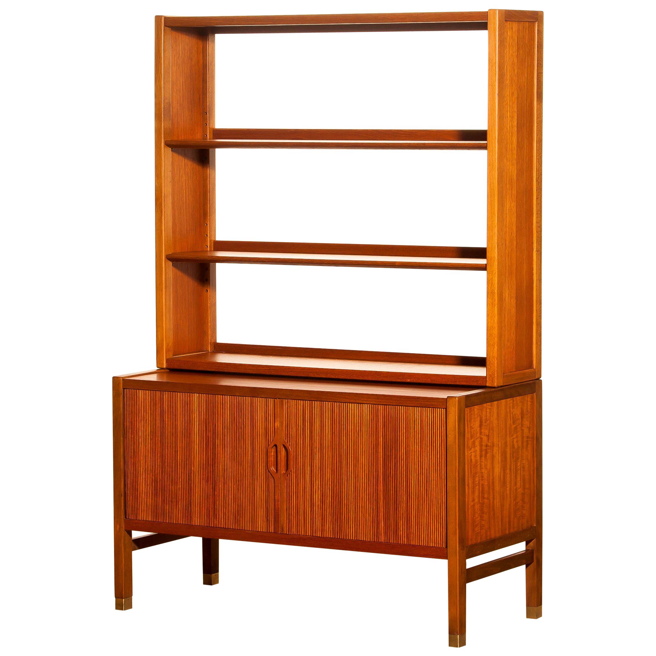 Very beautiful and elegant teak cabinet with tambour doors by Carl-Axel Acking for Bodafors, Sweden.
The lower part of the cabinet has two tambour doors and inside an adjustable shelf. The top part has two adjustable shelves. All in perfect