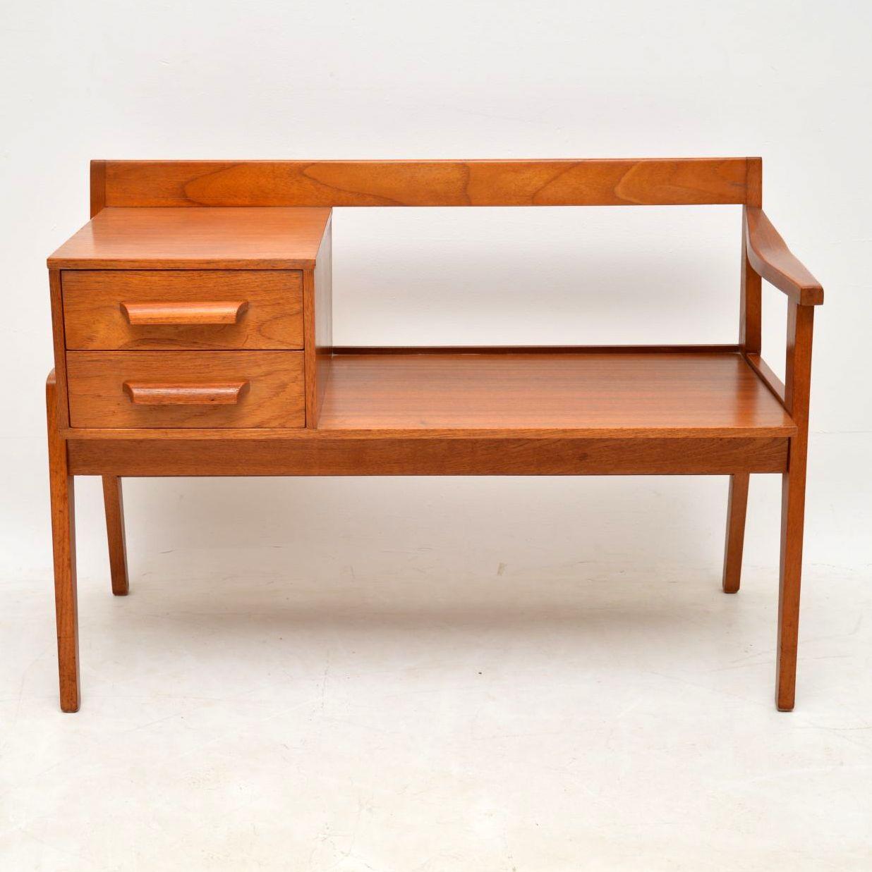 A beautiful and stylish entry bench that is designed for use as a telephone table, this dates from the 1960’s. It’s really well made and is in superb condition for its age, with only some extremely minor wear here and there.

Width – 92 cm , 36
