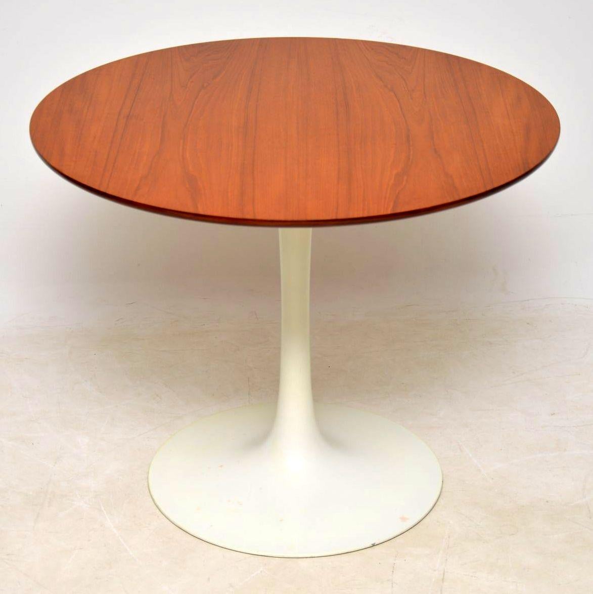 A stylish and iconic vintage dining table, designed by Maurice Burke for Arkana, dating from the 1960s. This rarely seen teak topped version has a white metal tulip shaped base, the top is a useful size, big enough to dine from, but not too