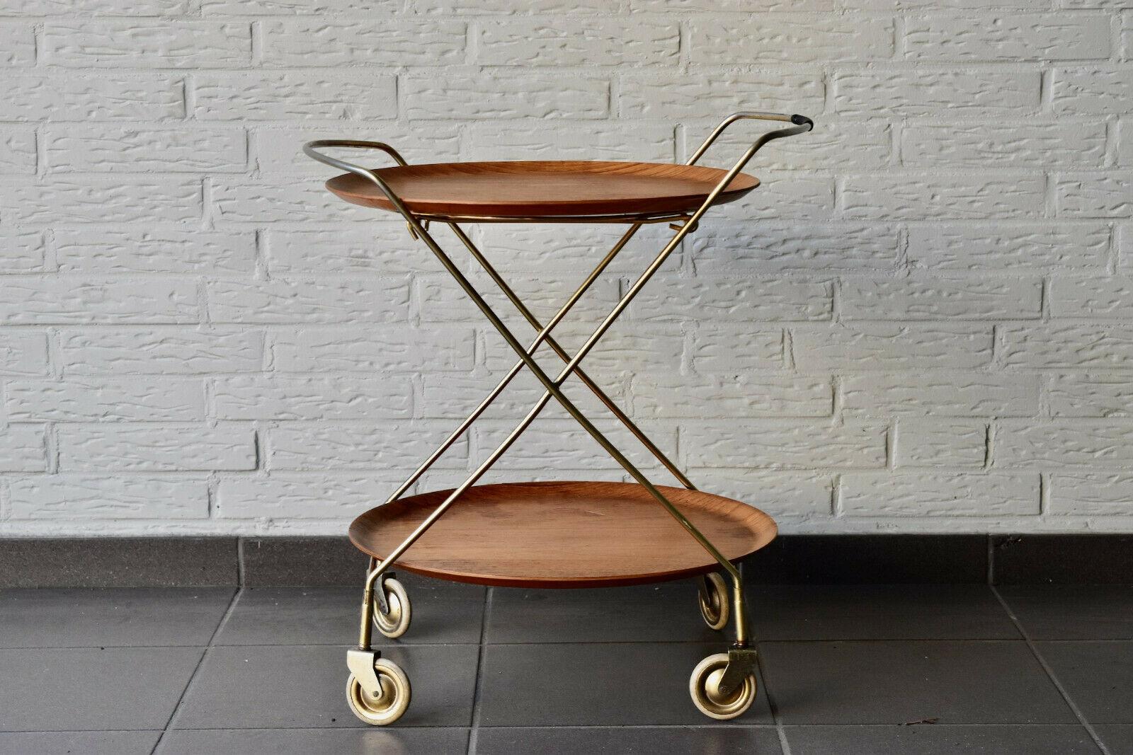 Scandinavian Modern two-tier rolling teak and gold colored metal serving cart. Design and produced by J.H Fabrikerna, Savsjo Sweden in 1960s. Nice vintage condition.