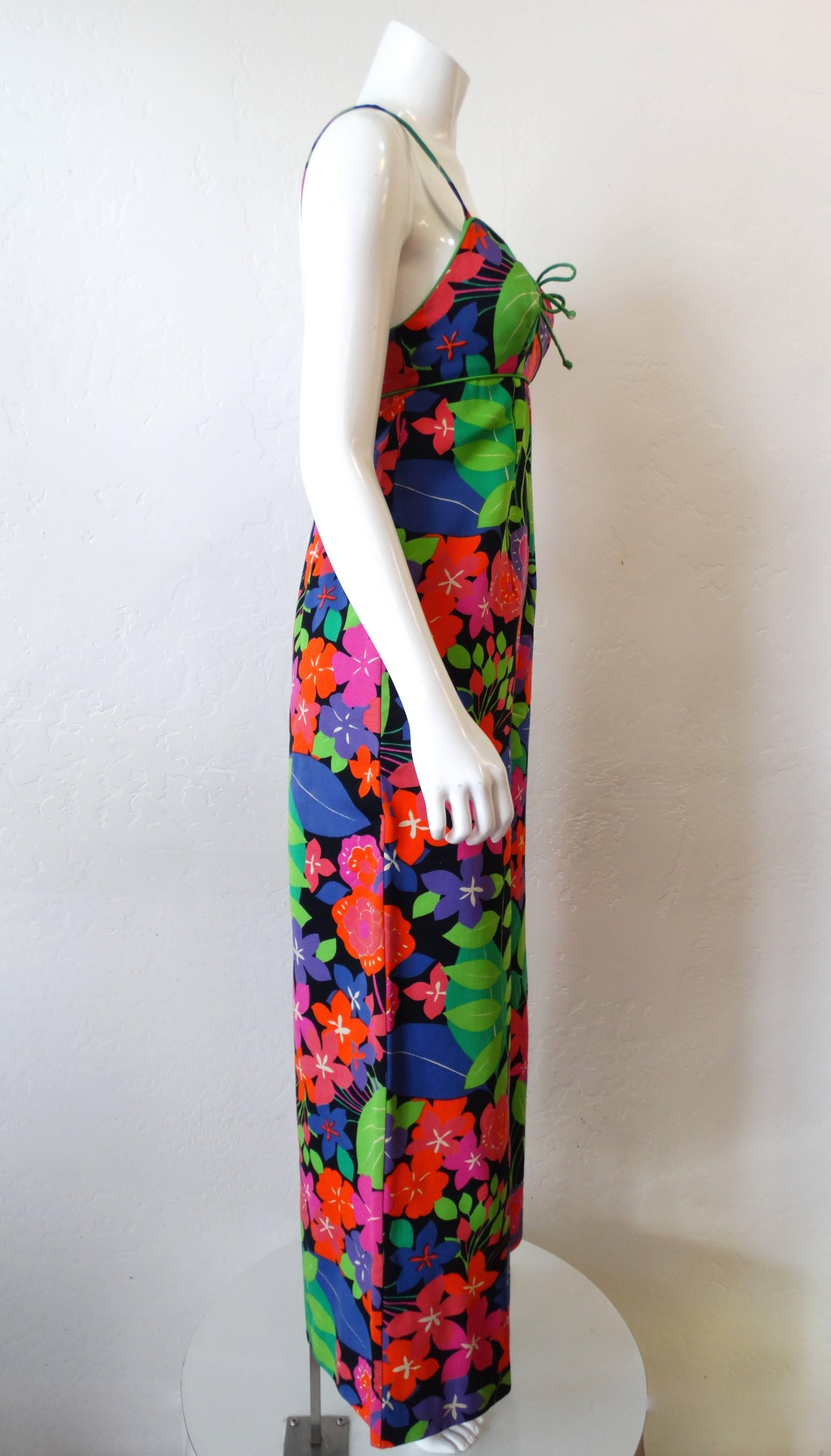 We love a good jumpsuit- and you will too with our amazing 1960s technicolor floral jumpsuit! Sleeveless, spaghetti strap fit with wide flare legs. Covered in an amazing neon leafy floral print on a black solid background. Trimmed with bright green