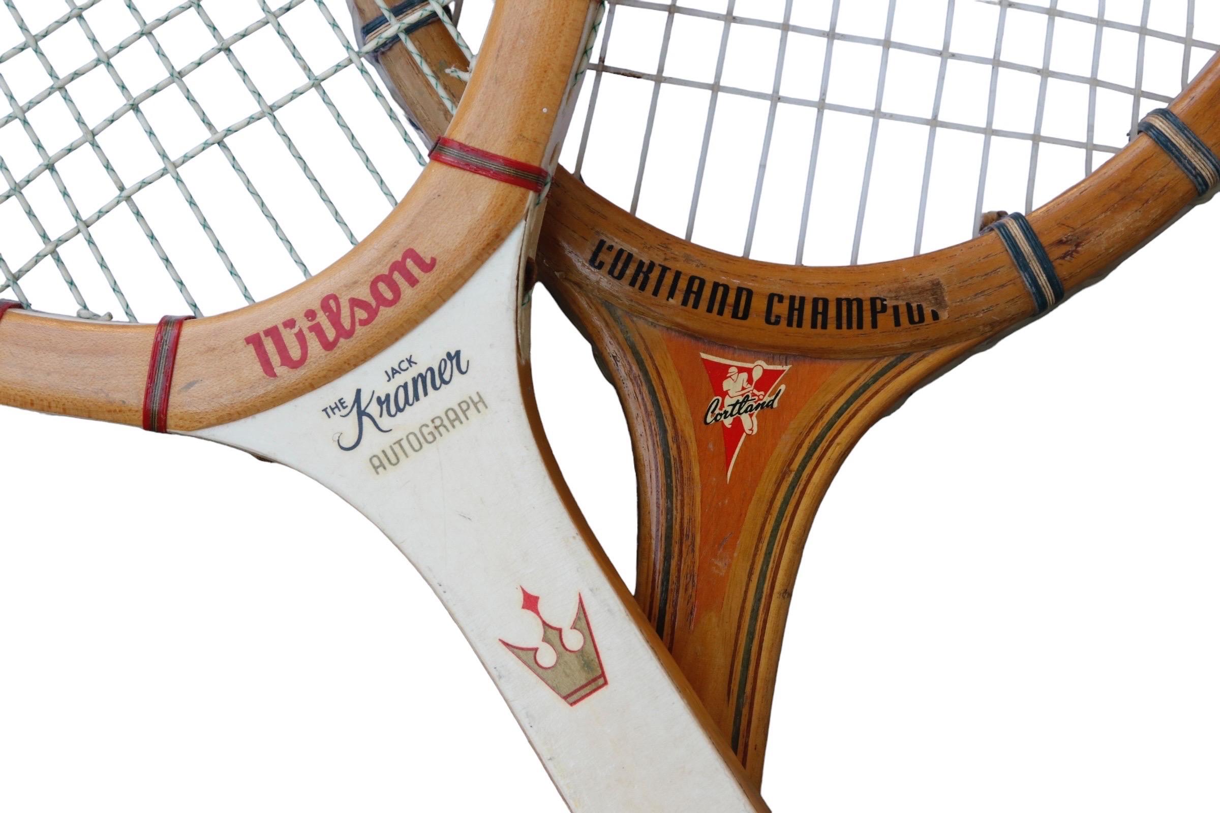 Two vintage tennis rackets dating from the mid 1960’s. A Wilson ‘Jack Kramer Autograph’ racket has a white neck decorated with a three-prong gold crown lined in red. A Cortland Champion racket has the Cortland logo on the neck. Both handles are