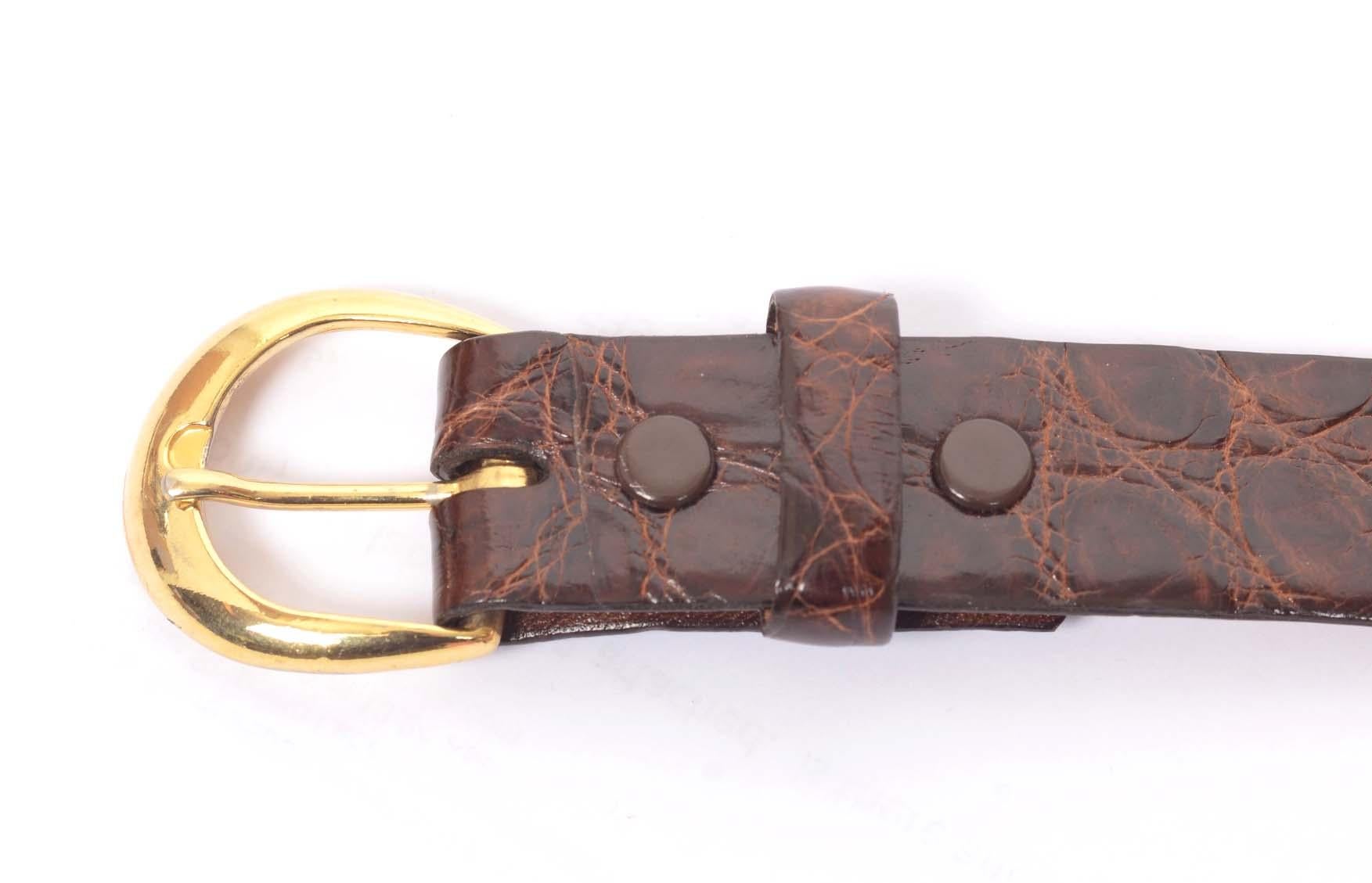 1960's Tex Tan brown alligator skin belt has a gold tone d-ring notched closure with 5 notches and is lined in brown cowhide. From domestic tanned alligator.

Additional measurements- Waist 23