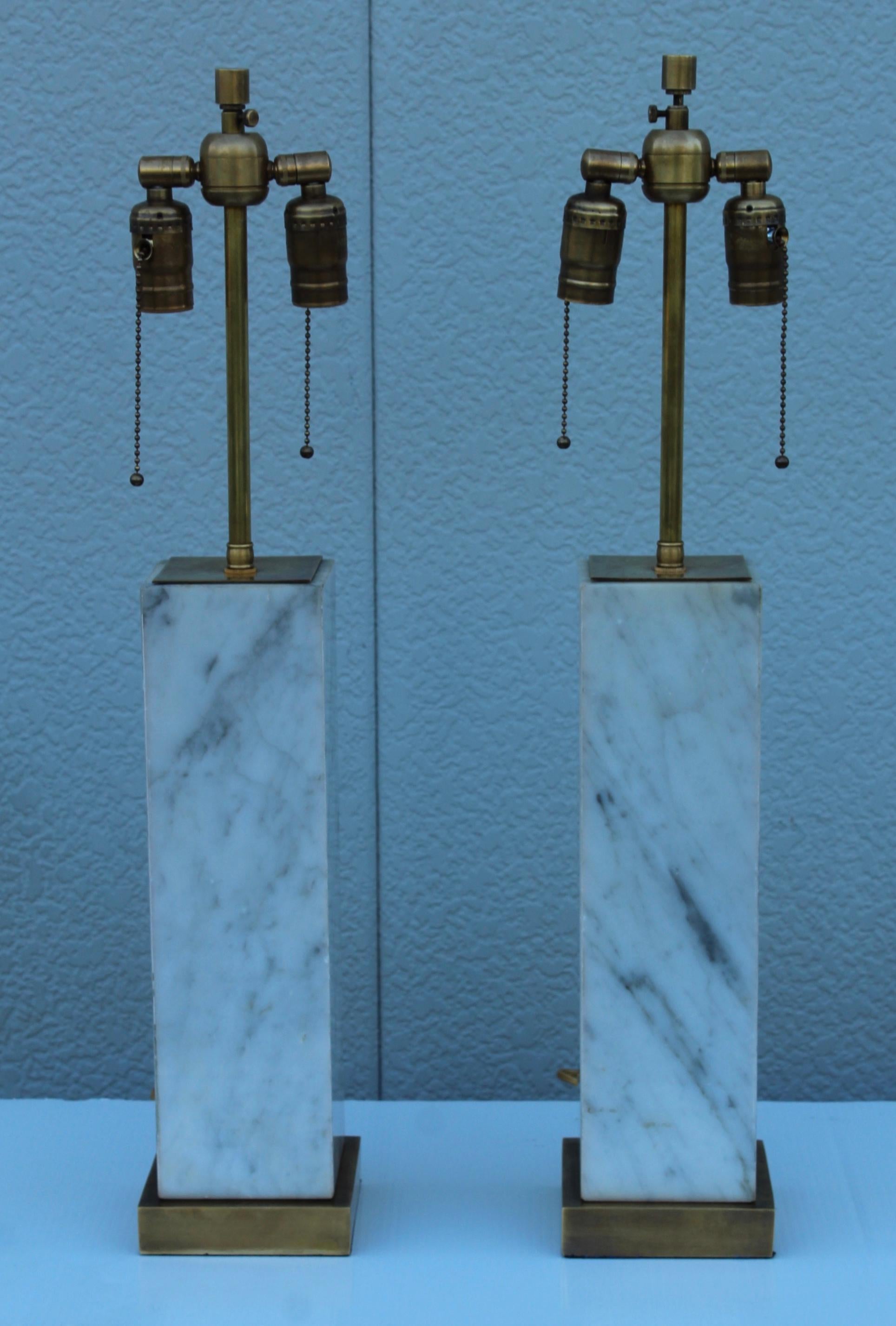 1960's Mid-Century Modern brass and marble table lamps in the style of Robsjohn Gibbings marble bases are made in Italy, in vintage original condition with some wear and patina to the marble there is some wear and a few chips to the marble, newly