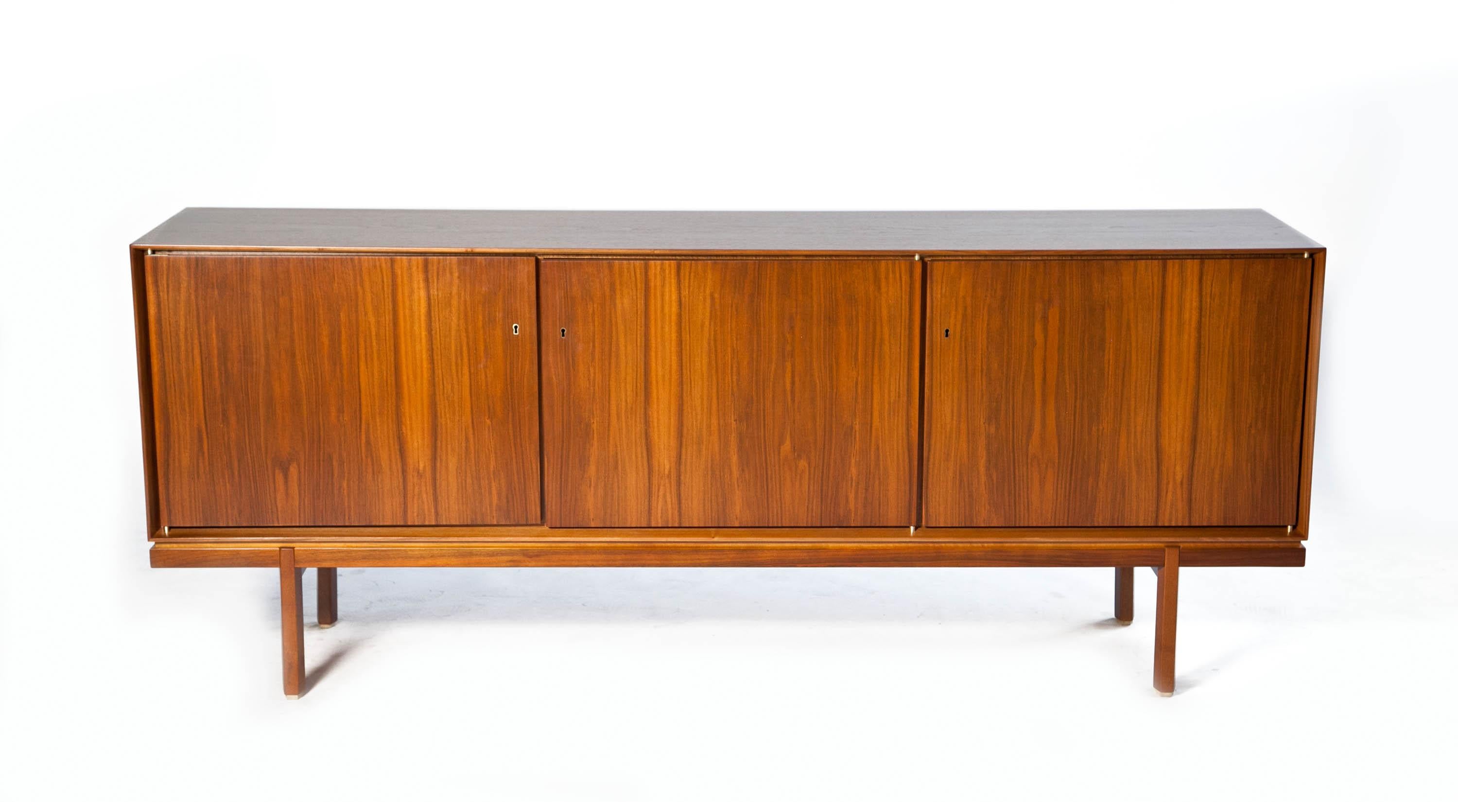 1960s thin edge three door walnut credenza - mid century danish 

Exquisite Thin edge walnut credenza with elegant details. Finley refinished to in excellent conditions with gorgeous european walnut grain covering this very unique piece. Three