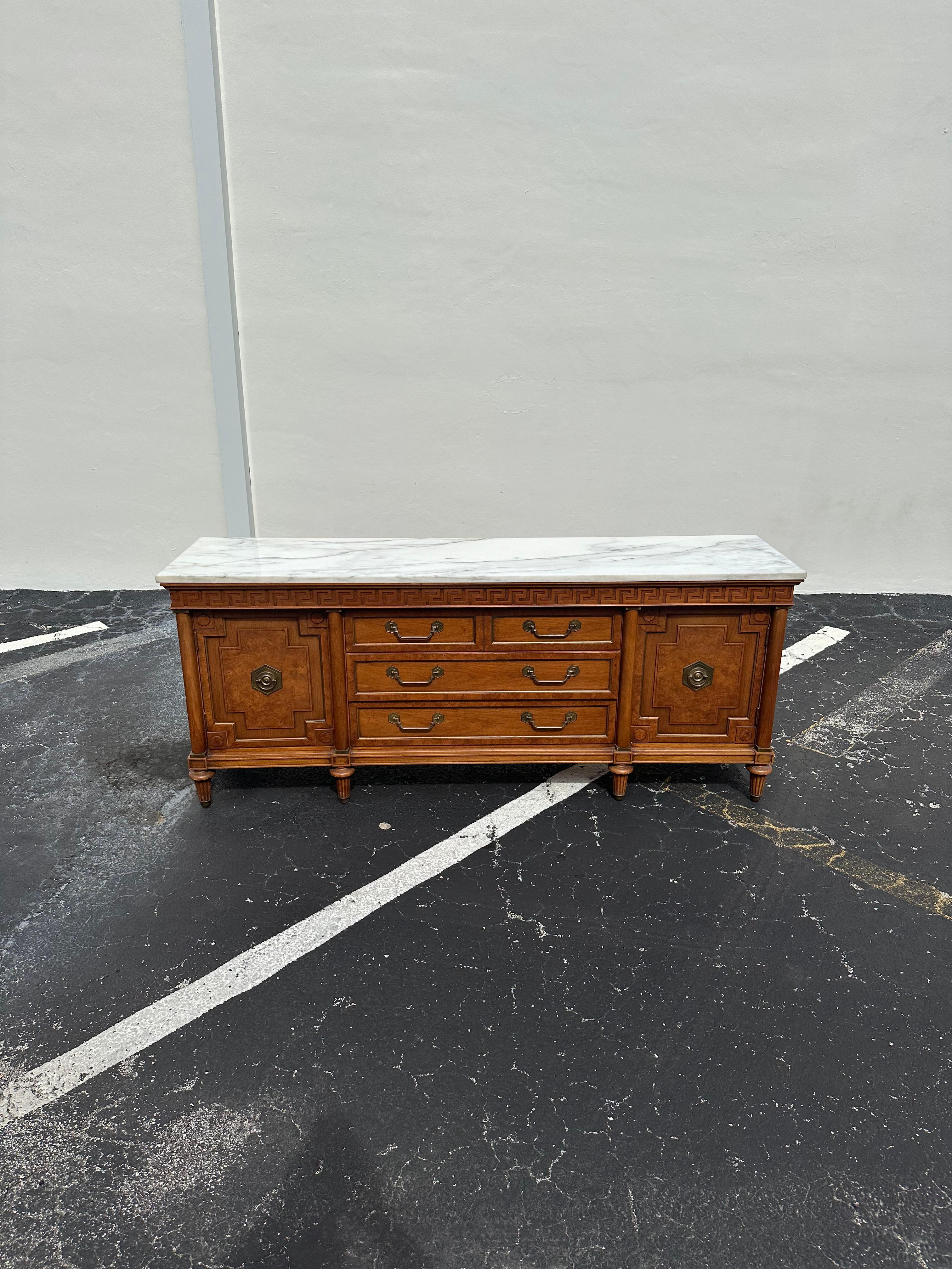 Indulge in the timeless elegance of this exquisite credenza sideboard buffet, dating back to the 1960s. Crafted with meticulous attention to detail, this piece showcases a stunning hand crafted finish, ensuring a rich, lustrous appearance that