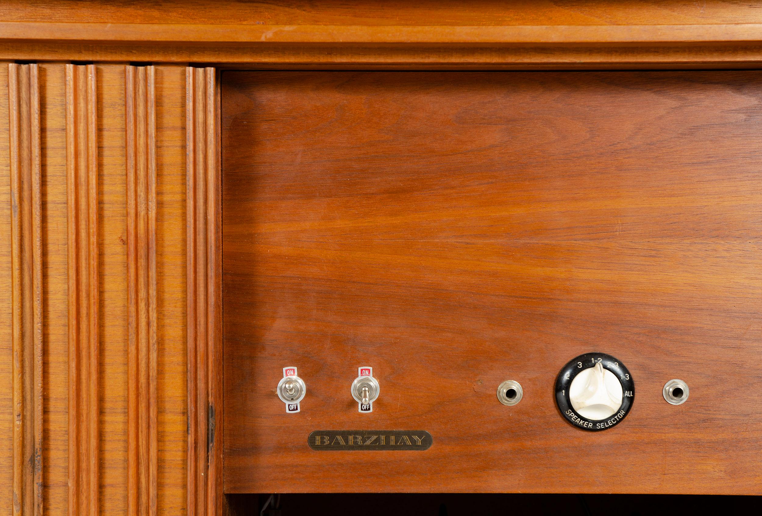 A three-piece tambour door walnut stereo cabinet designed and manufactured in the USA by Barzilay.
