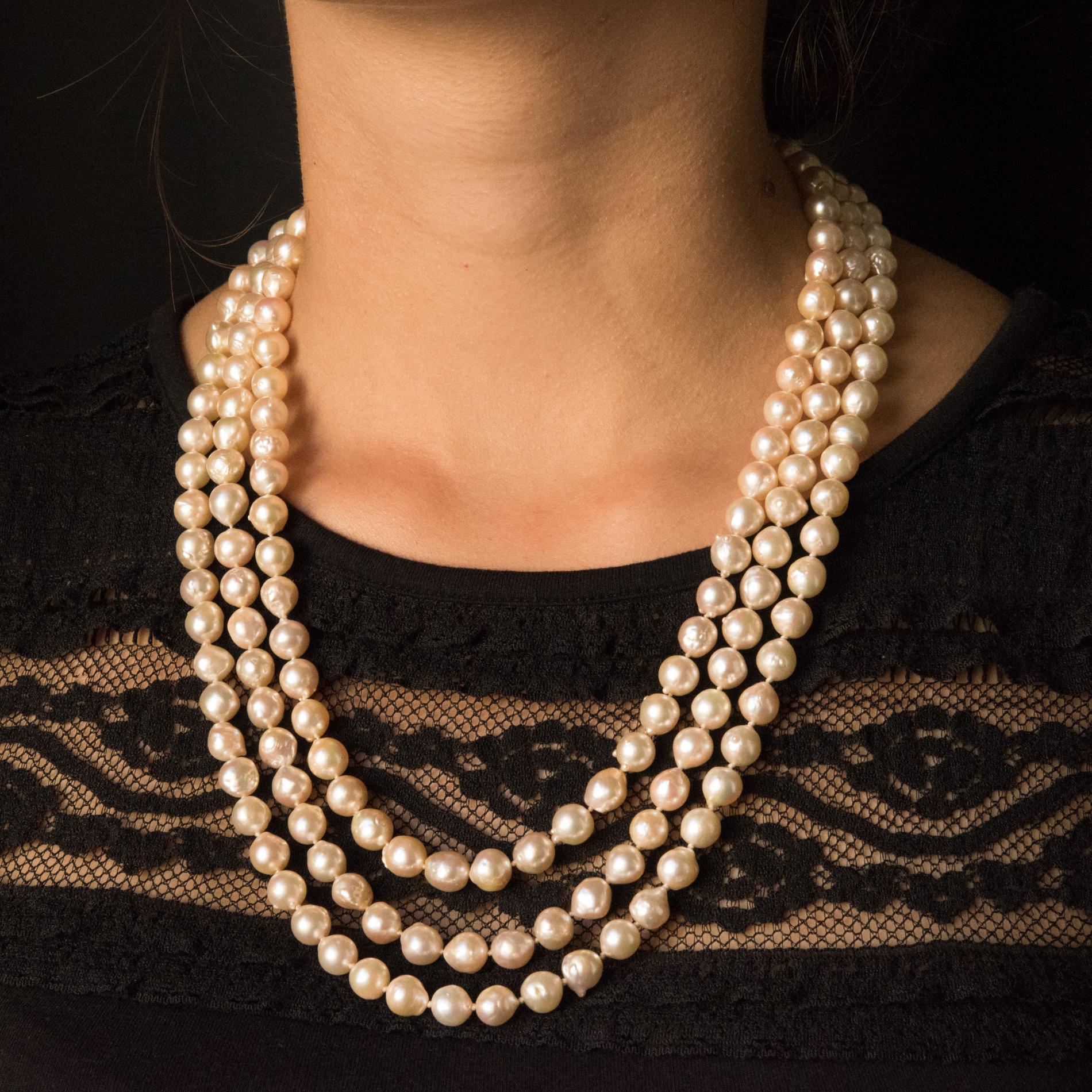 Necklace made of 3 strands of 172 baroque cultured pearls of identical size with a white orient.
The rectangular ratchet clasp is in 18 karats yellow gold, owl hallmark. It is smooth and comes with a safety chain and a safety 8 with spring