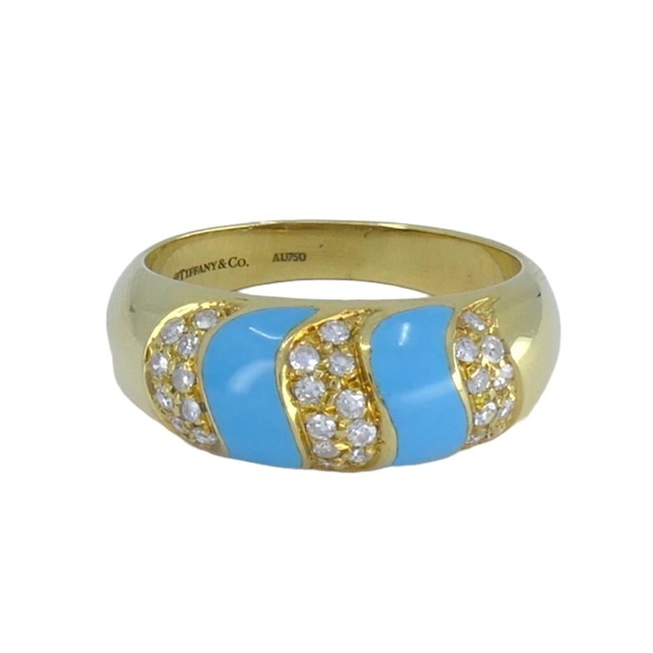 Classic Tiffany & Co ring features a beautifully textured 18K yellow gold band encrusted with double vivid blue turquoise S shaped bands highlighted with brilliant-cut diamonds set in S shaped swirls. Thirty (30) diamonds totaling .40 carats. Total