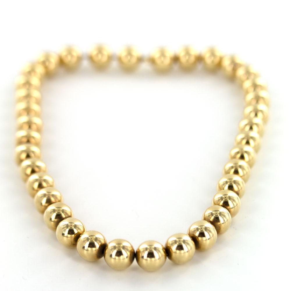 1960's gold ball necklace by Tiffany & Company. The vintage necklace features 11mm balls fashioned in 14 karat yellow gold. The necklace measures 16 inches in length. Signed Tiffany. 