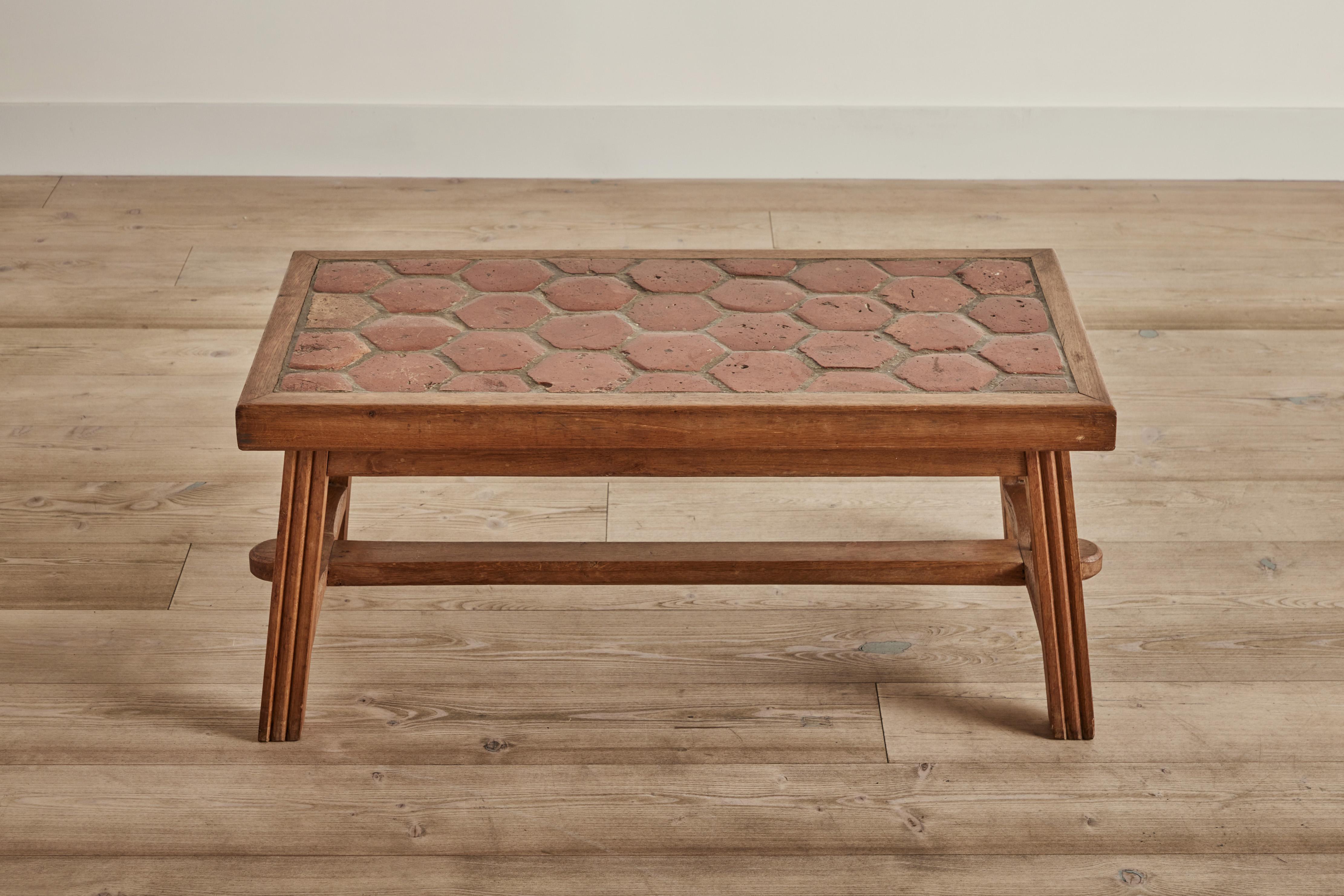 1960s wood and terracotta tile top coffee table from France. Wear on tile and wood is consistent with age and use.