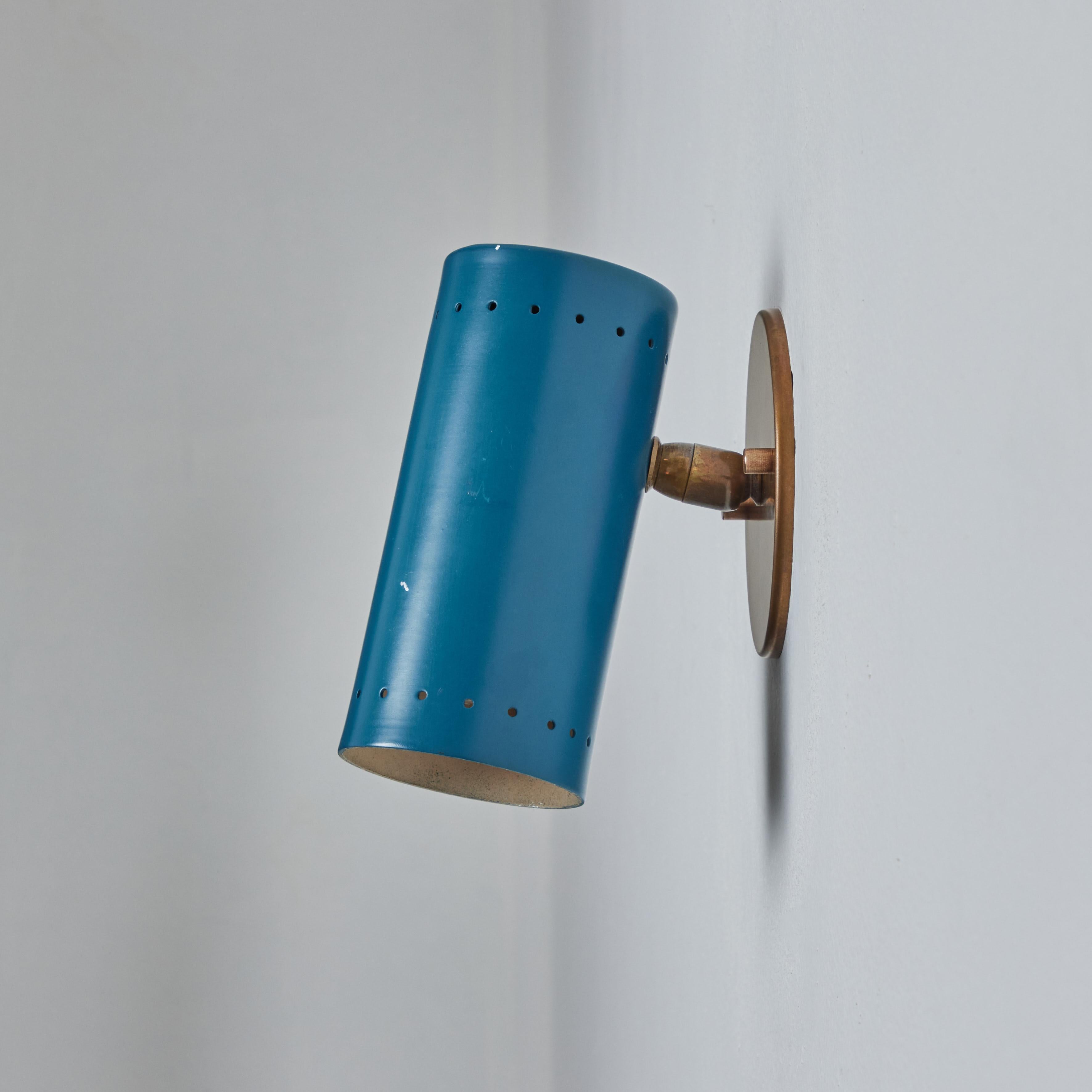 1960s Tito Agnoli blue perforated metal and brass articulating sconce for O-Luce. One of his most highly refined Minimalist designs. Sleek and functional yet at the same time bright and playful. A highly adjustable wall light, the tubular shade
