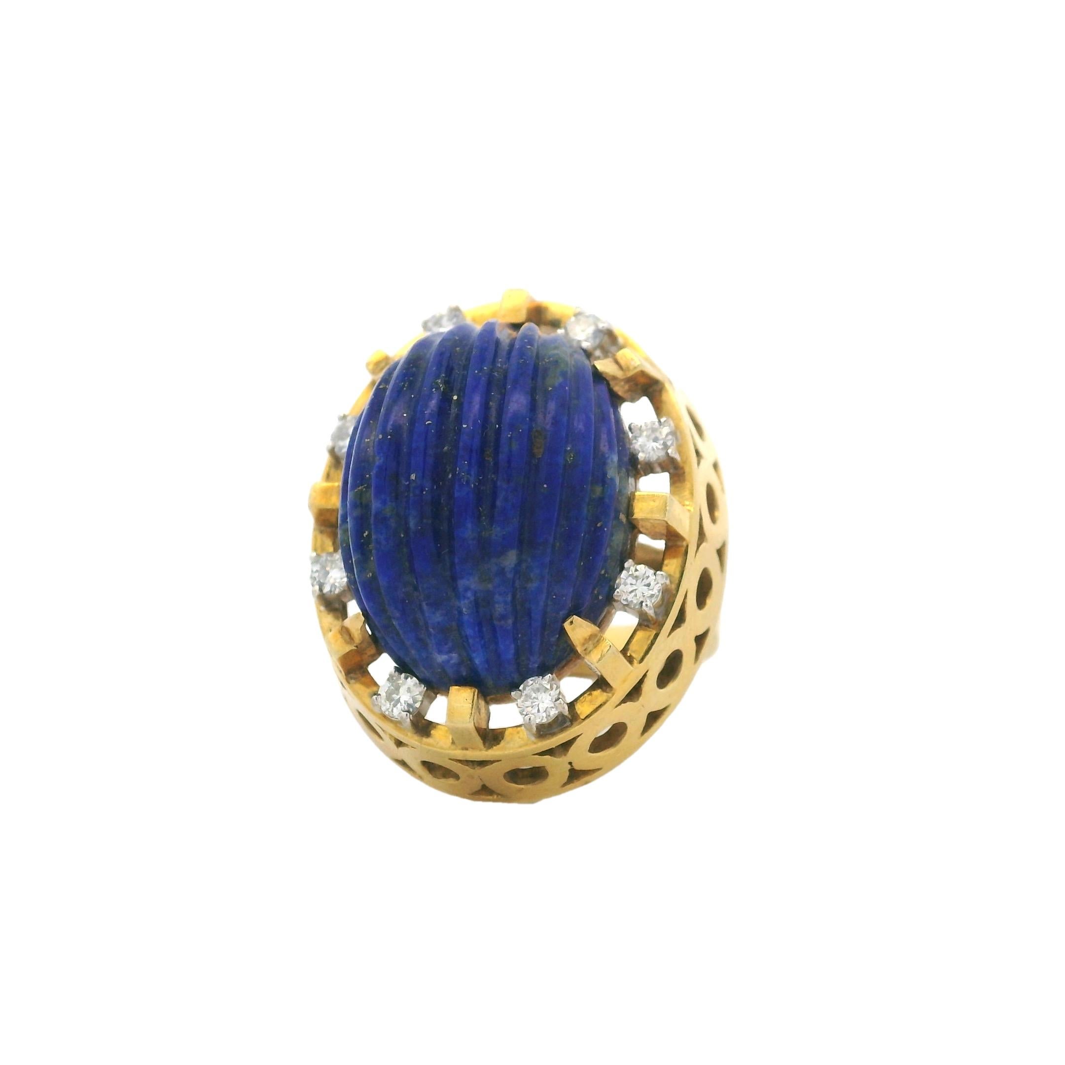 A bold and sculptural design from the 1960s, this vintage Toliro cocktail ring features a richly fluted lapis lazuli cabochon set in a striking openwork dome of 18K yellow gold. The intense royal blue lapis is bezel-set and accented with