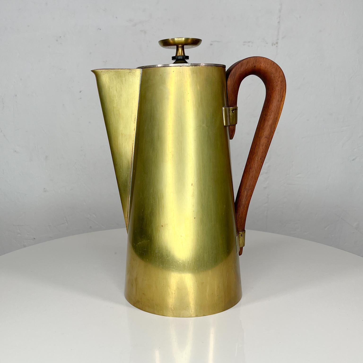 Designer Tommi Parzinger modern brass coffee tea service pot with silverplate. Sculptural walnut wood handle.
Stamped Dorlyn Silversmiths. 
Measures: 12 tall x 8.5 depth x 5.5 diameter
Unrestored vintage condition with patina
Refer to all