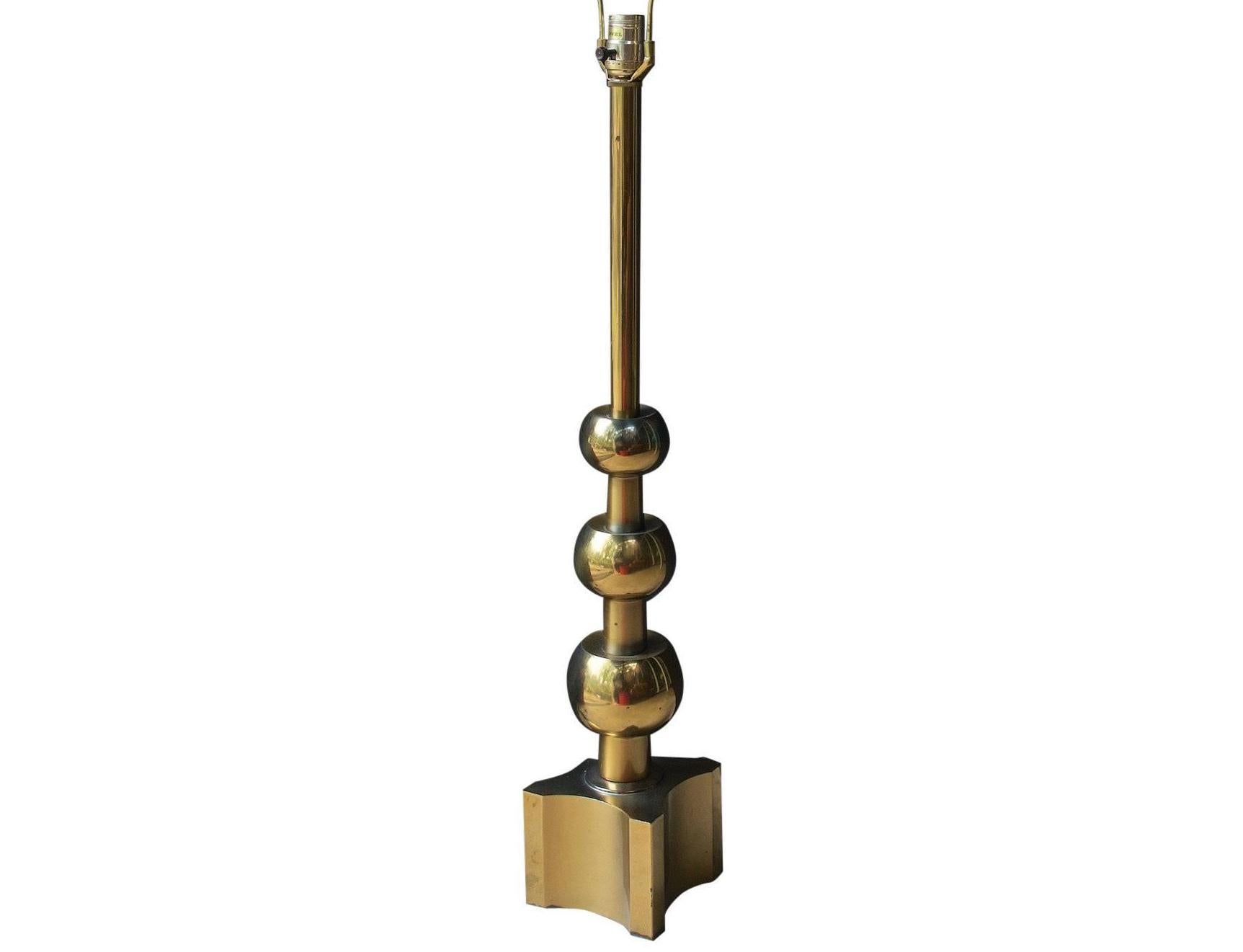 Tommi Parzinger for Stiffel tall brass table lamp in the Art Deco style. A Classic and stylish modernist lamp featuring a stepped three-ball design terminating in a x-block base. 
Dimensions: H 27 inches: W 5.5 inches 
Condition: Very Good; some
