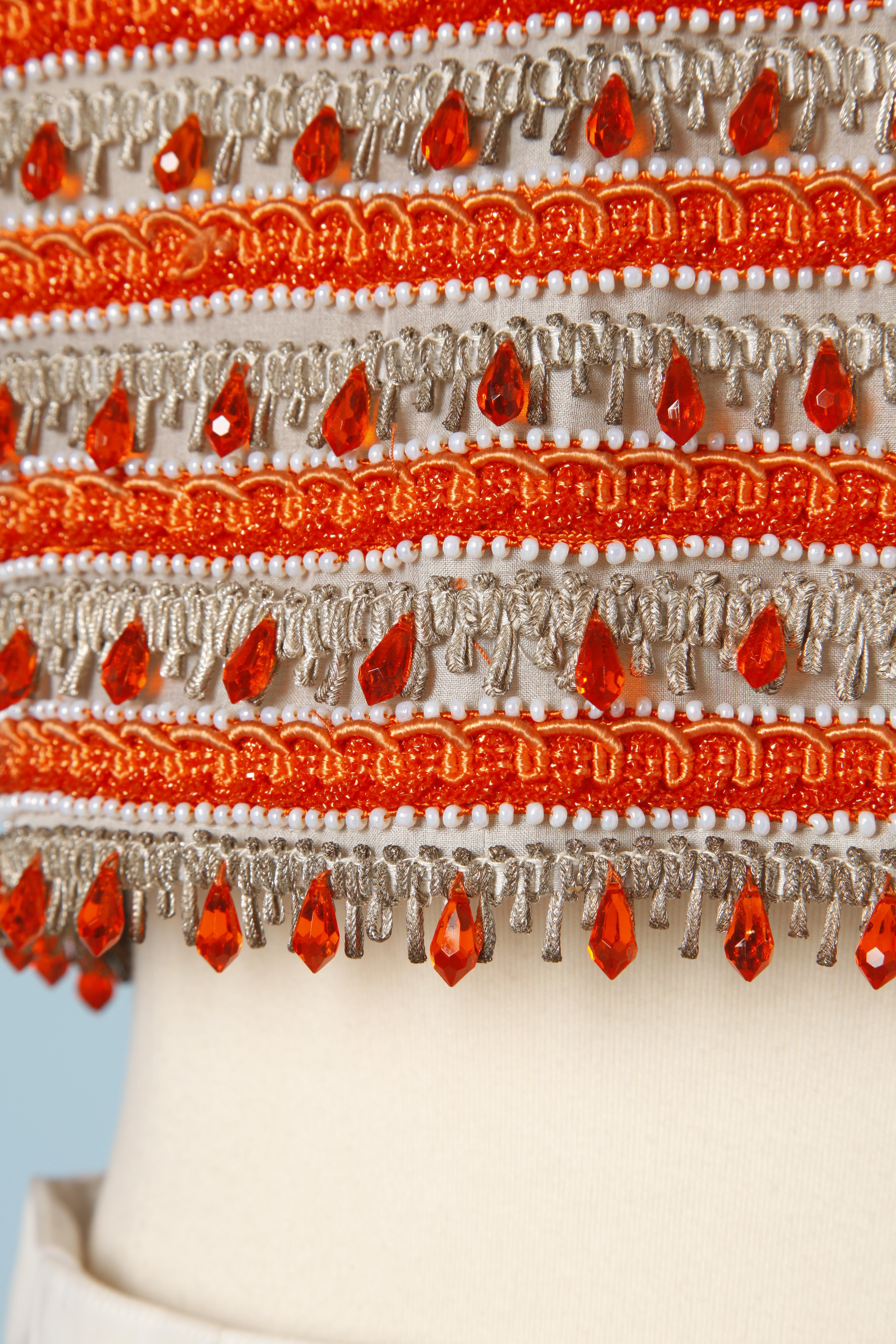 Beige 1960's top with orange and white beads and silver and orange passementerie 