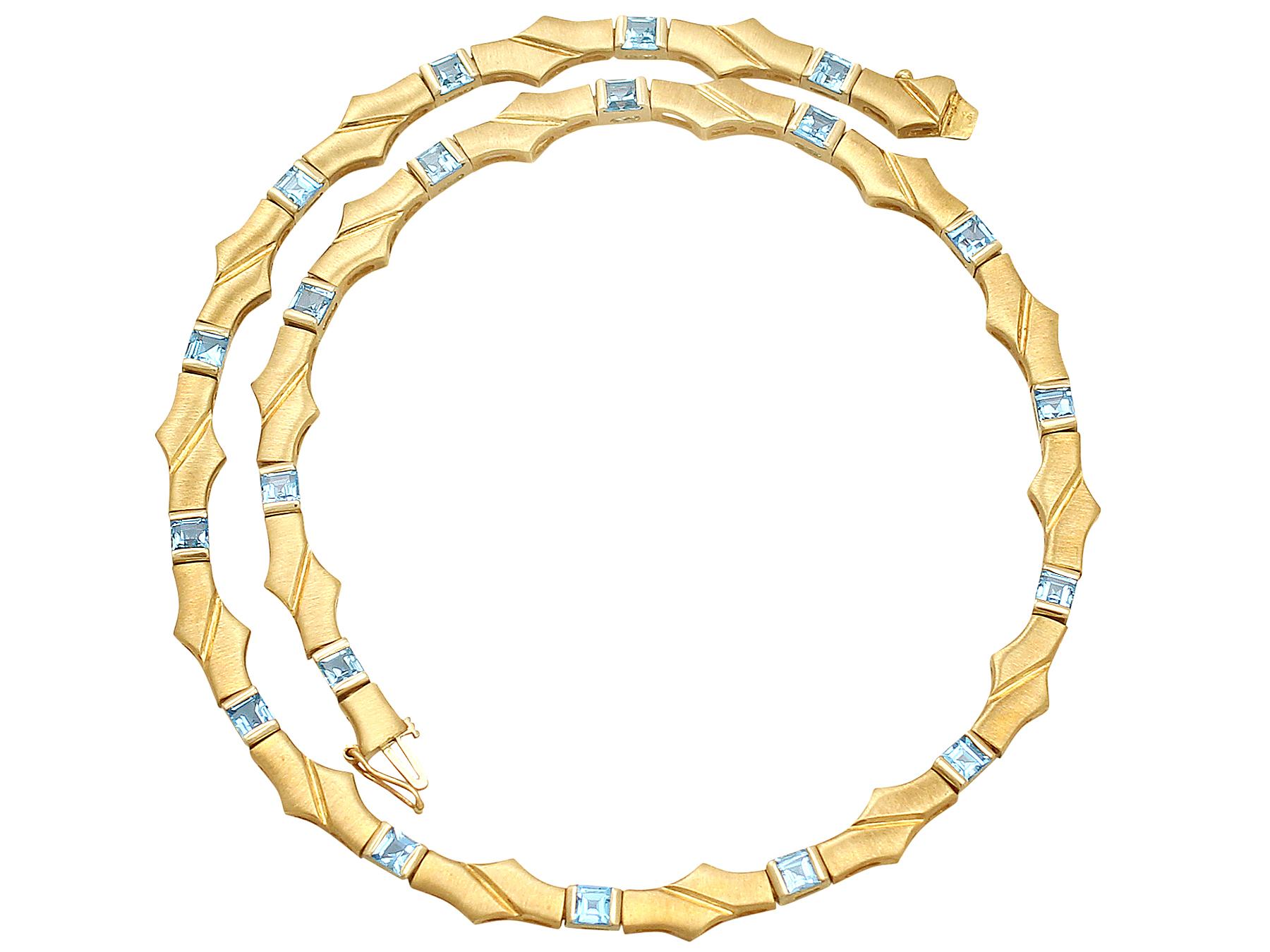 A fine vintage natural blue topaz, 9 karat yellow gold necklace; part of our vintage jewelry and estate jewelry collections.

This fine vintage topaz necklace has twenty pierced decorated articulated links crafted in 9k yellow gold with a satin