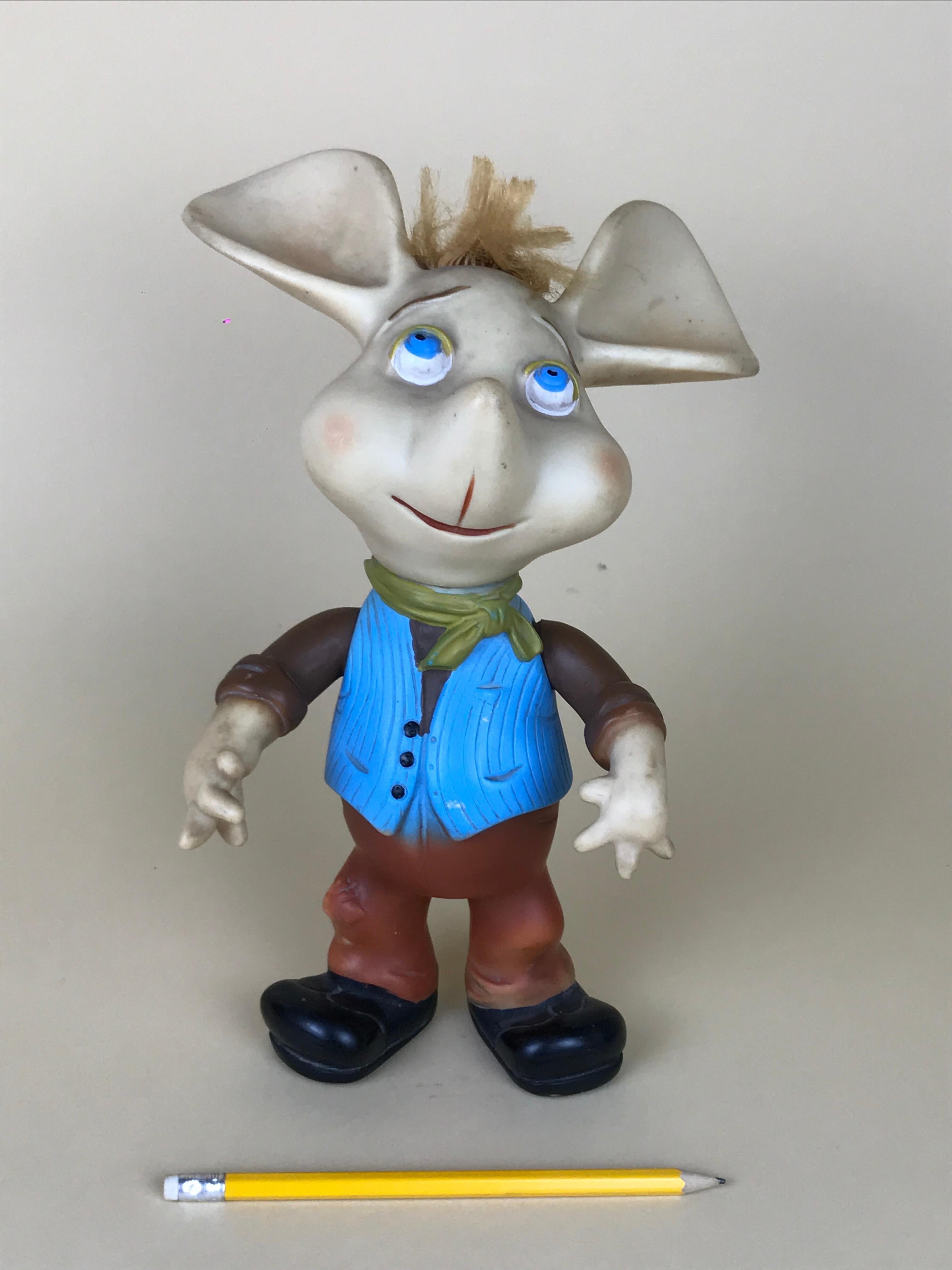 1960s iconic Topo Gigio mouse rubber squeak toy made in Italy, designed by Maria Perego in 1958.

The toy wears a country look with blue waistcoat and green handkerchief. 
It has movable arms.

The whistle of this rubber toy is