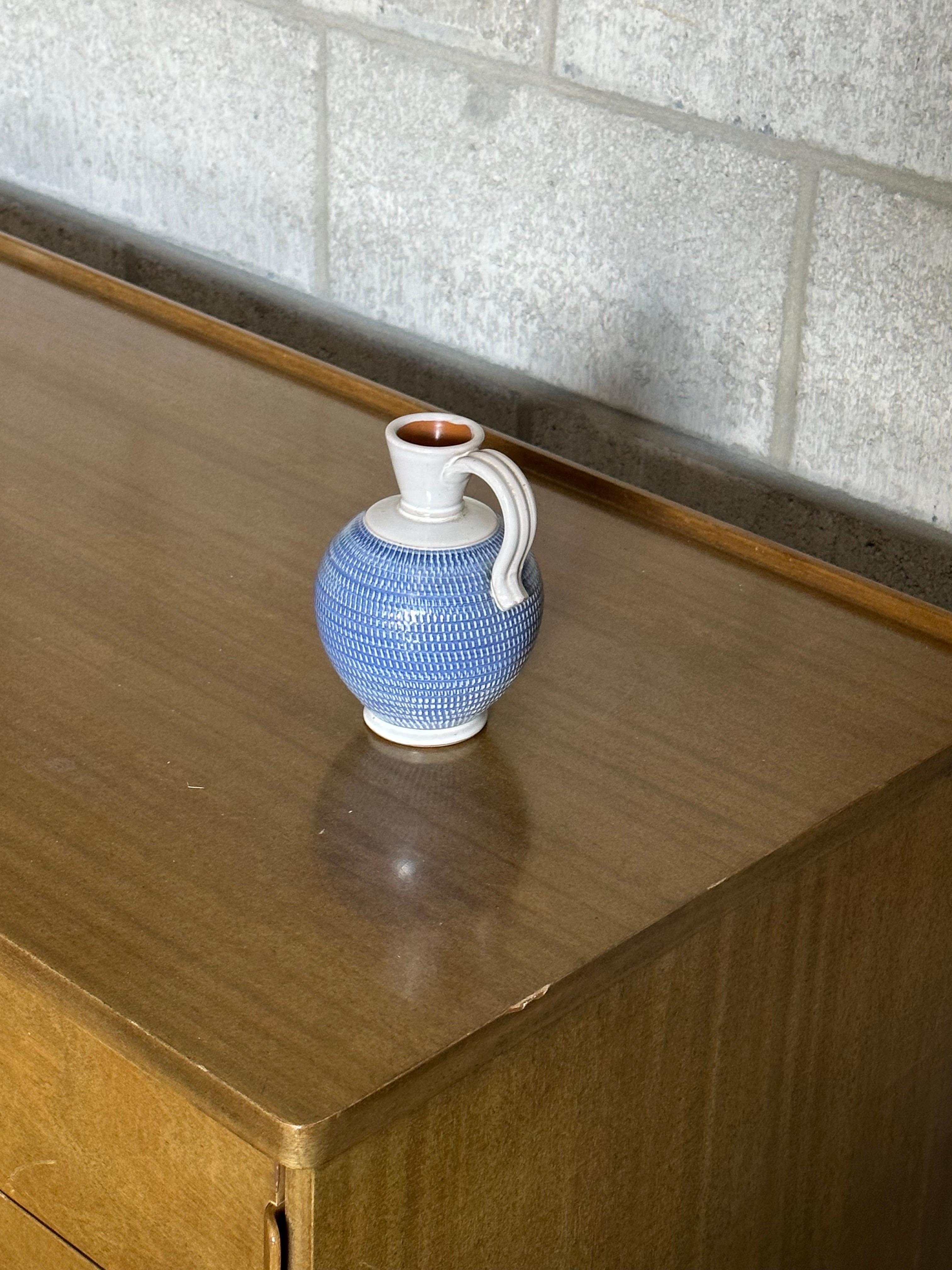 Very nice small pitcher vase produced by Töreboda in Sweden circa 1960s. Features a nice form and classic colors that would blend seamlessly into a variety of interiors. 