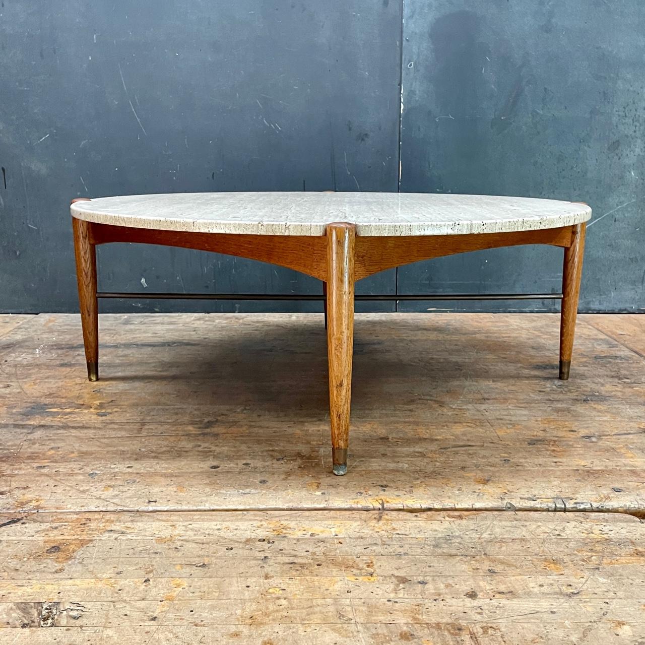 Sweden, c.1960. Travertine marble, oak, brass round low coffee table. Burnished marked, Made in Sweden, DUX. 

All original and from the original owners estate, all patina has been preserved for the next owner. No damage to stone top, base is strong