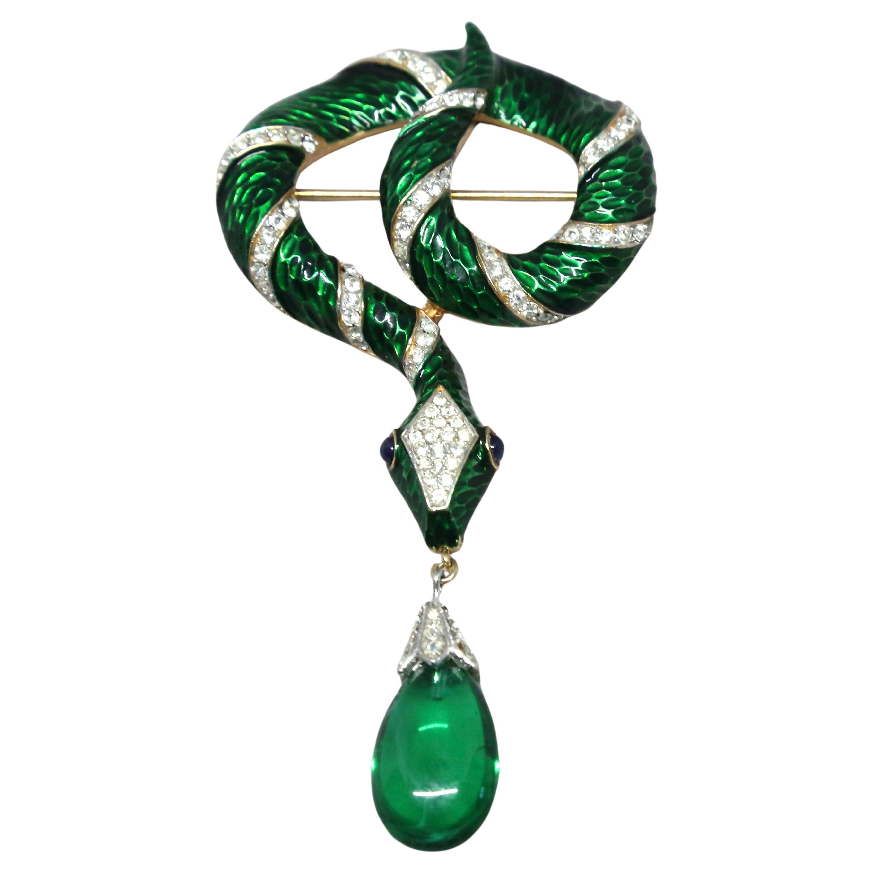 Very rare, 'Garden Of Eden' serpent brooch with green enamel, pave rhinestones, blue glass eyes and dangling emerald crystal pendant designed by Alfred Philippe for Trifari dating to the 1960's. Exactly as seen in original Trifari ad. Brooch has