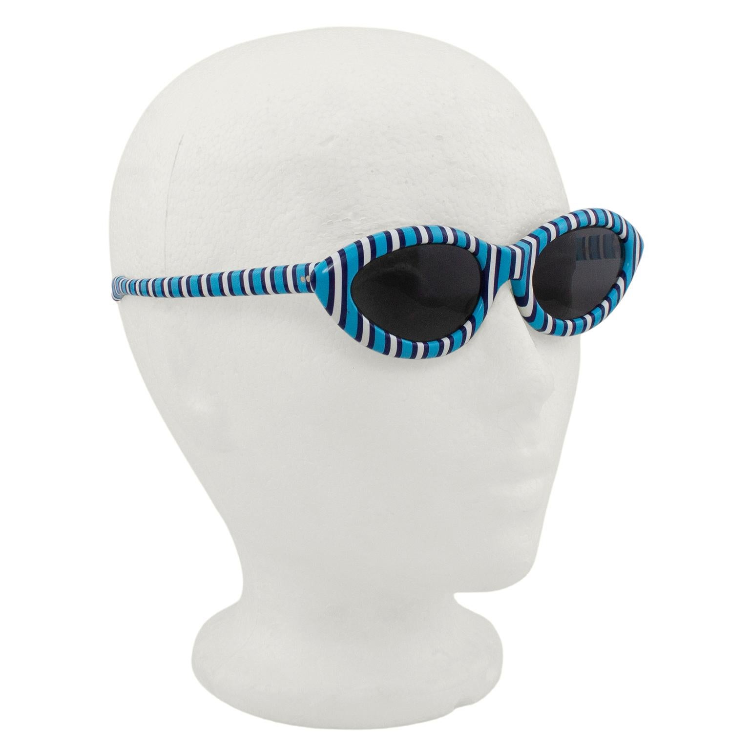 These are the perfect sunglasses for a whirlwind European vacation! Cerulean, navy blue and white vertical stripe cat eye sunglasses by Trifari, best known for manufacturing decades of fabulous costume jewelry. Based on the mod shape and style,