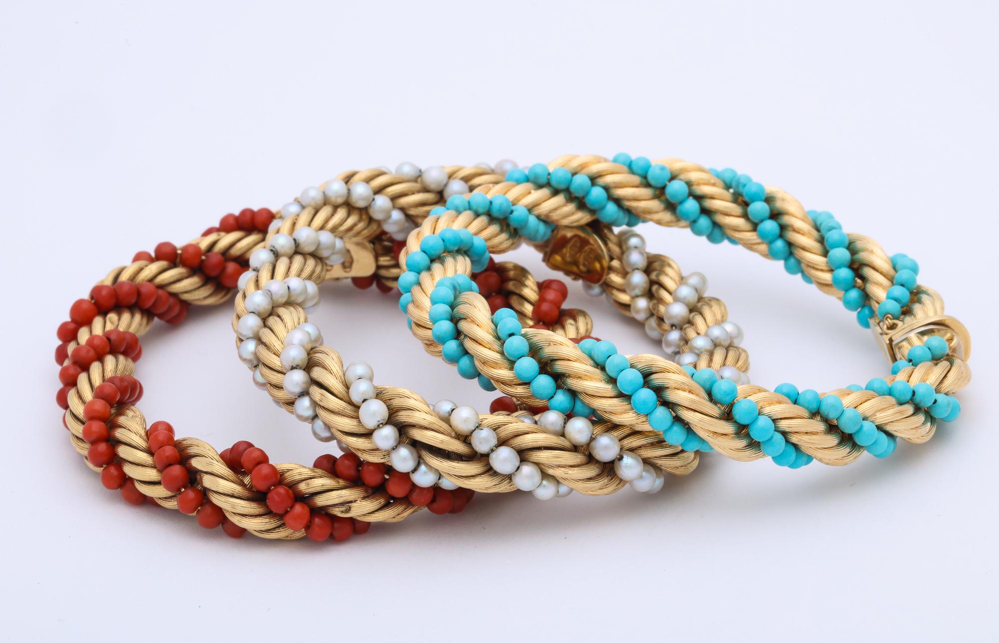 Triple Set Of 18kt Yellow Ridged Twisted Rope Design Gold Flexible Bangle Bracelets Composed Of One Alternating Coral Beads And Alternating Turquoise Beads And Last Stack Consisting Of 2MM Pearls,2 MM Turquoise Beads And Numerous 2MM Coral Beads.