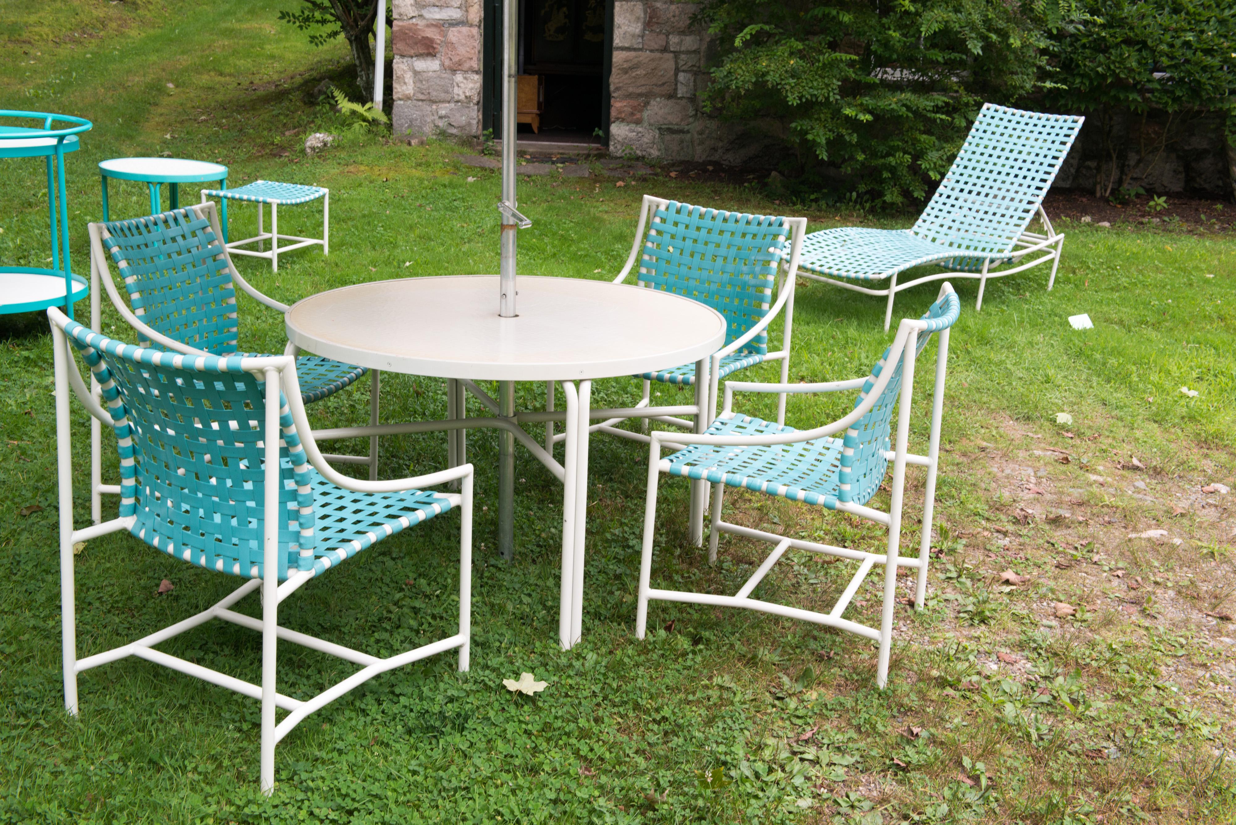 Think 007. Quintessential 1960s Chic! White powder coated aluminum frames with turquoise vinyl webbing. Multi colored canvas fringed umbrella with big ball finial. Everything is in excellent condition. All original. Really looks new! There are