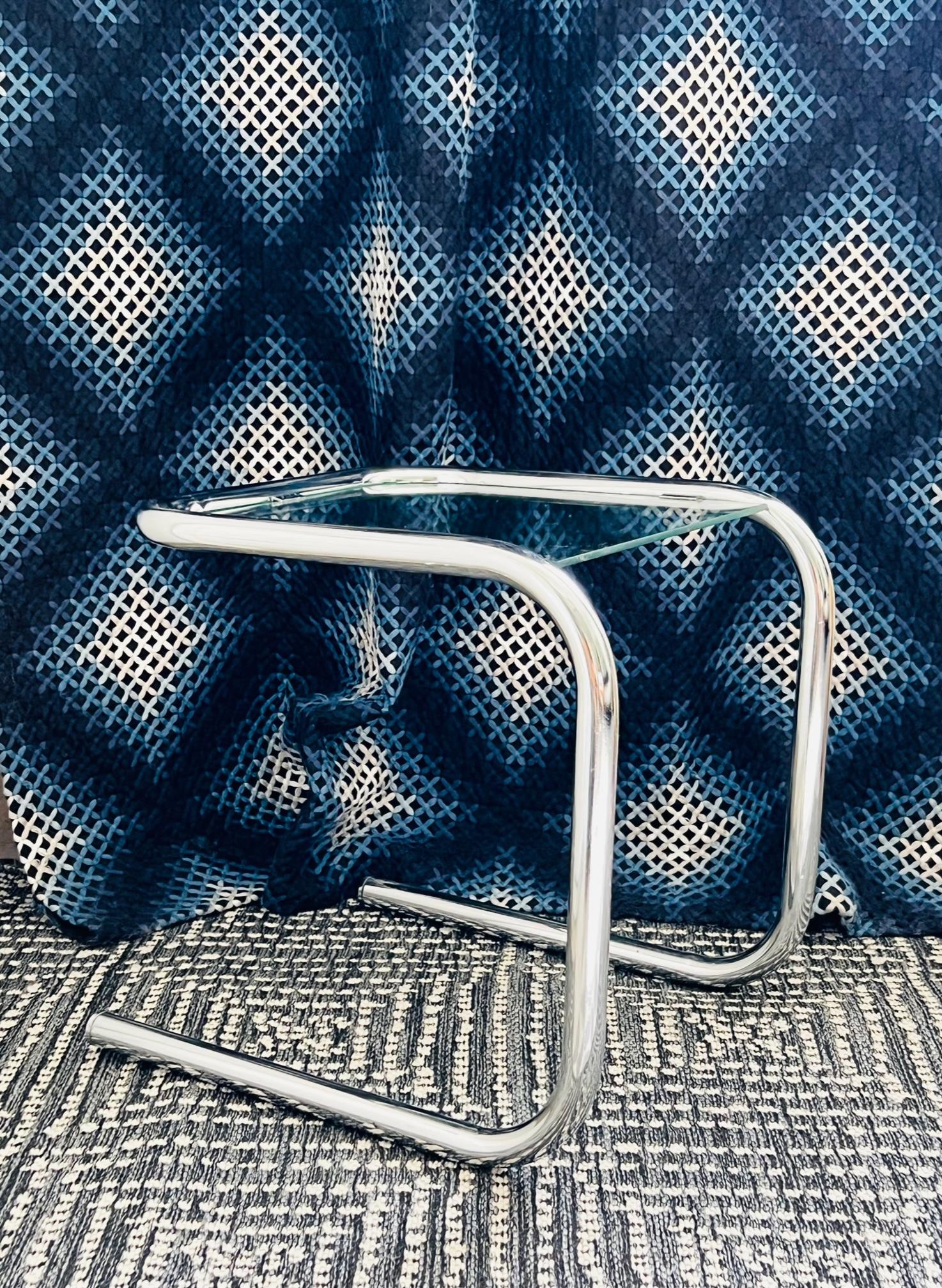 Mid-Century Modern Bauhaus style small tubular side table with floating glass top inset. Table features a cantilevered 