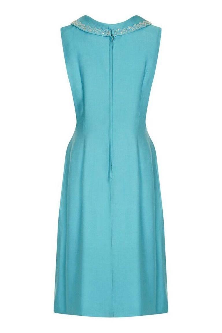 This lovely vintage 1960s linen mod dress in turquoise blue is smart and chic. The simple line and block colour is skillfully tailored but alas there is no maker's label present. There is fine detailed beadwork around the mini cowl neckline and the