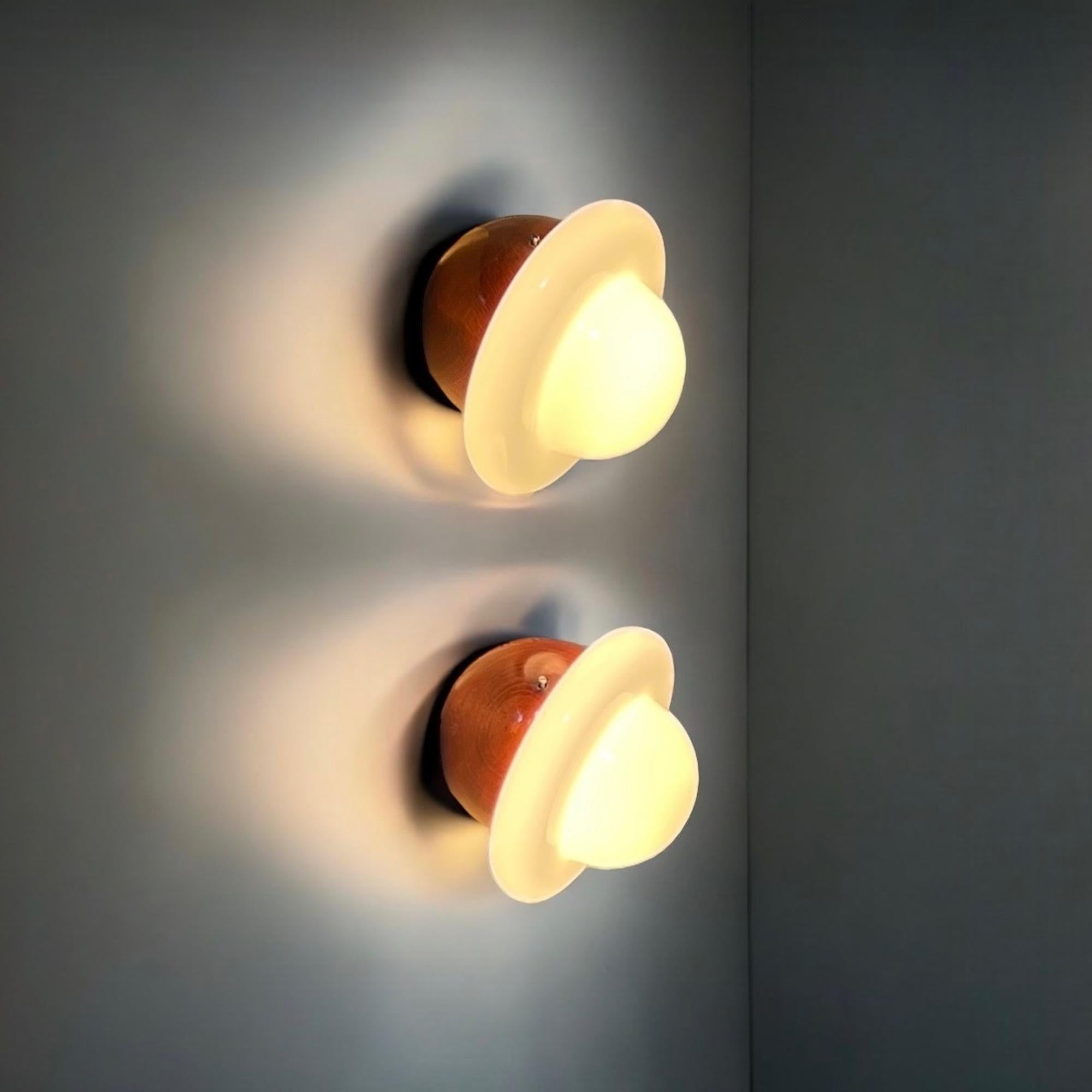 UFO lamp 1960s pair – a charming and almost unfindable set of wooden space age lamps that perfectly embodies the futuristic aesthetic of the late 60s and early 70s. Their iconic “flying saucer” shape, reminiscent of the era’s fascination with space