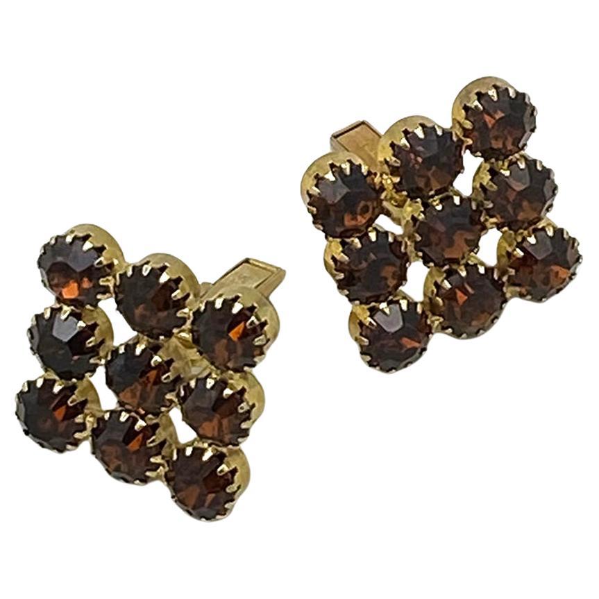 This is a pair of 1960s unisex topaz rhinestone cufflinks. They are Art Deco style large squares composed of nine pcs of 8mm topaz colored rhinestones prong sit on gold-tone metal. The pair are marked PAT. 2920363.  The patent number date system