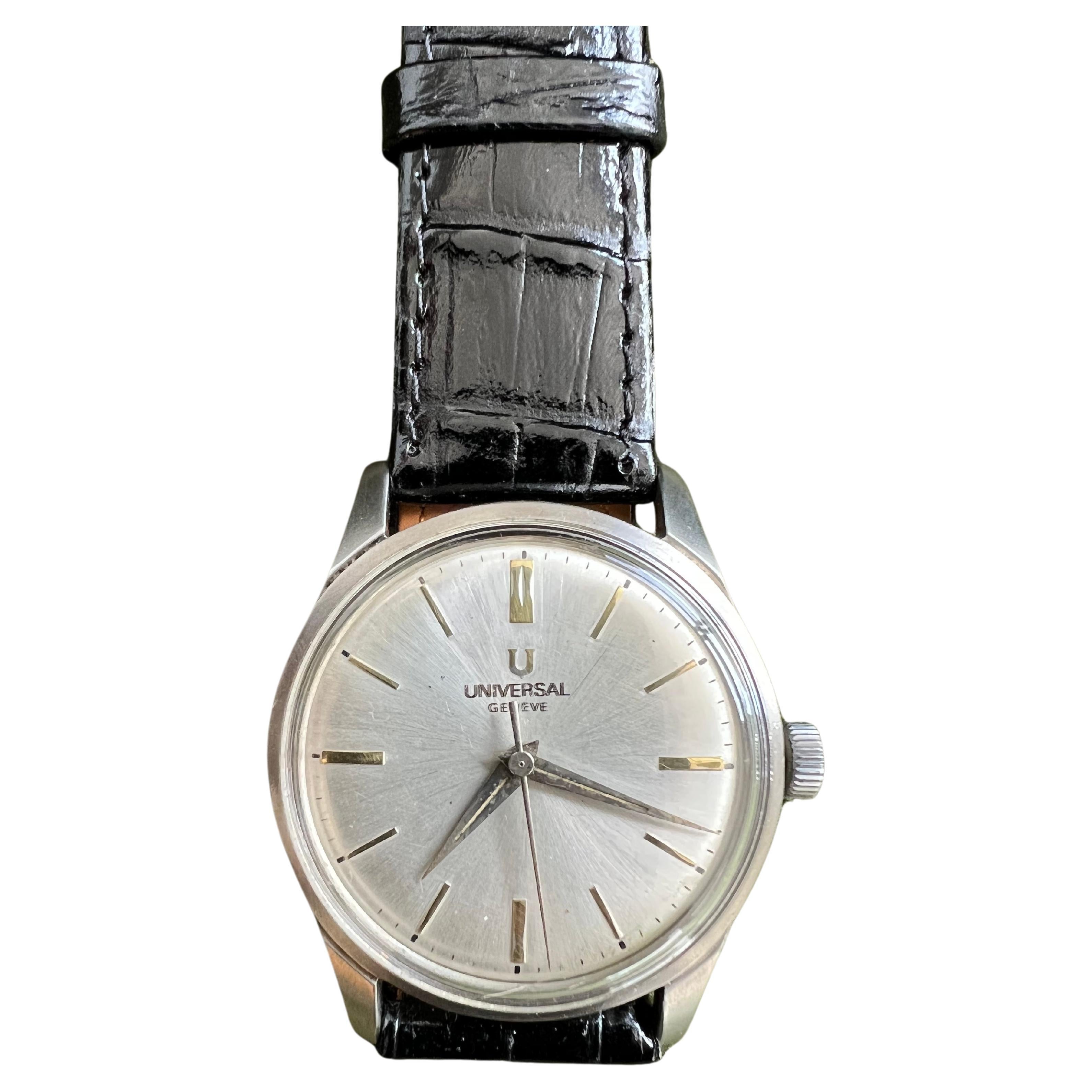 A pristine and classy dress watch from the early 60s.
White face and gold dials 
This watch features the classic proportions, both in size and slimness, that a dress watch should have. The dial is a silvery white colour, and has elongated batons at