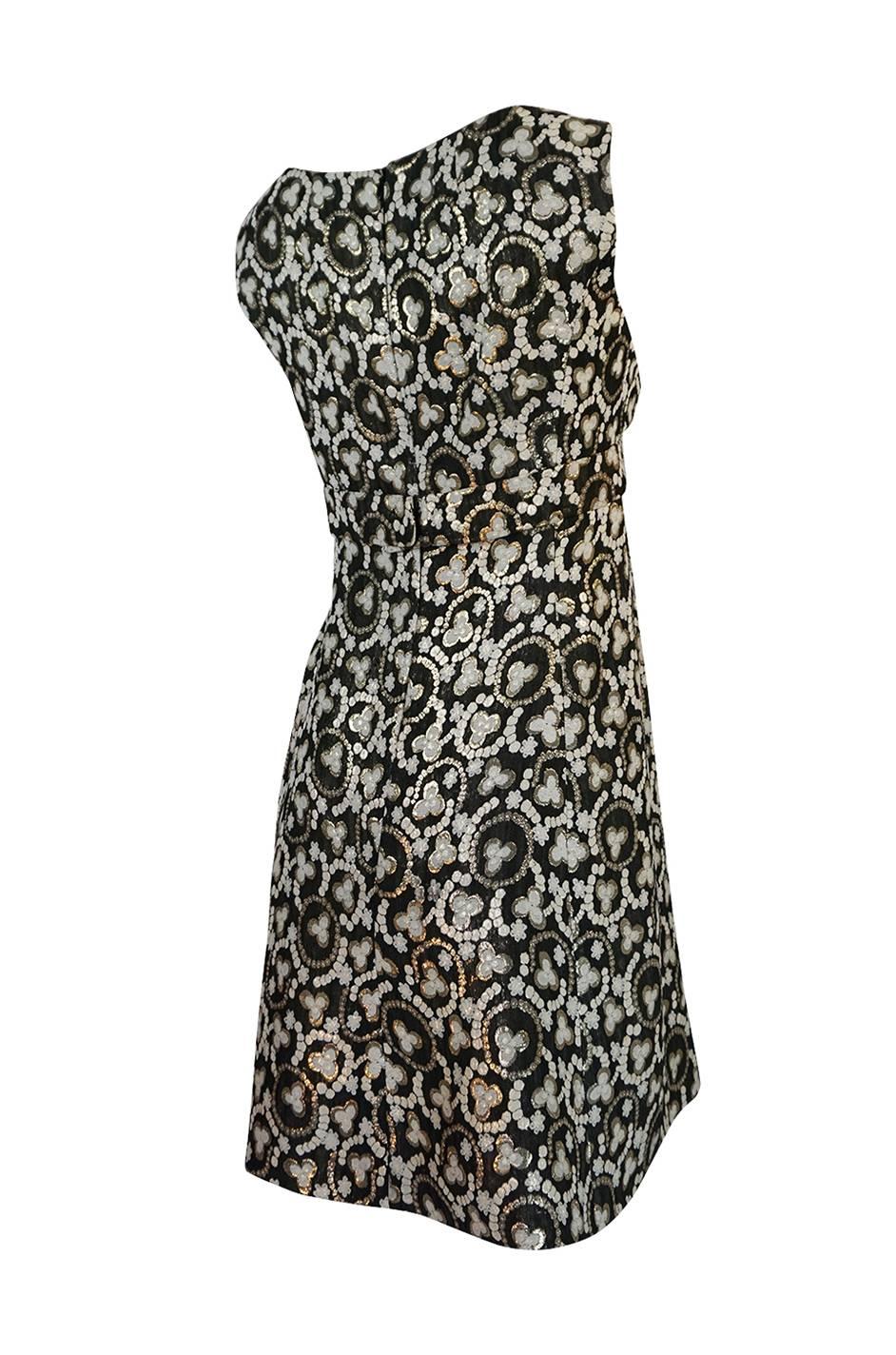 This is a gorgeous little metallic dress with a pretty print that combines a deep charcoal, gold and white. It has lost its label along the way but is a well made piece and I am guessing it had one at some point. The cut is simple and sweet with a