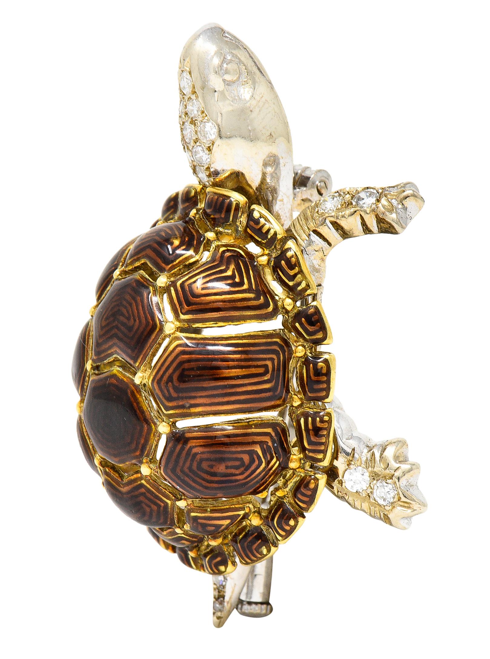 Brooch is designed as a tortoise turtle with a highly domed and tessellated shell. Yellow gold with a deeply grooved design - glossed with brownish orange enamel. Head and limbs are white gold and accented by round brilliant cut diamonds. Weighing