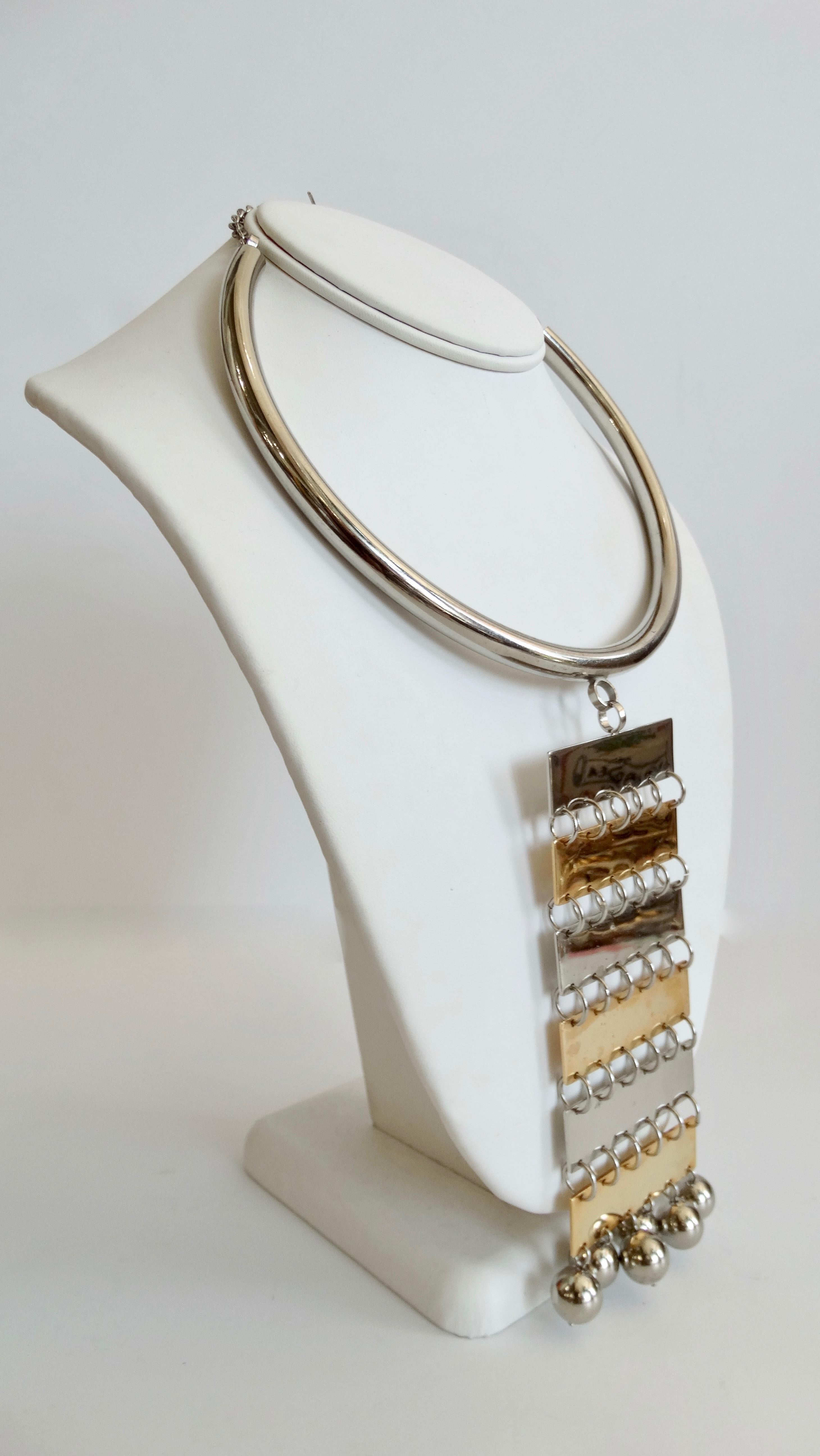 Elevate your outfit with this amazing artisan crafted choker necklace! Think Pierre Cardin Circa 1960s, this mixed metal necklace is plated in silver and gold. Features a thick silver plated band and a two-tone long chain-link pendant accented with