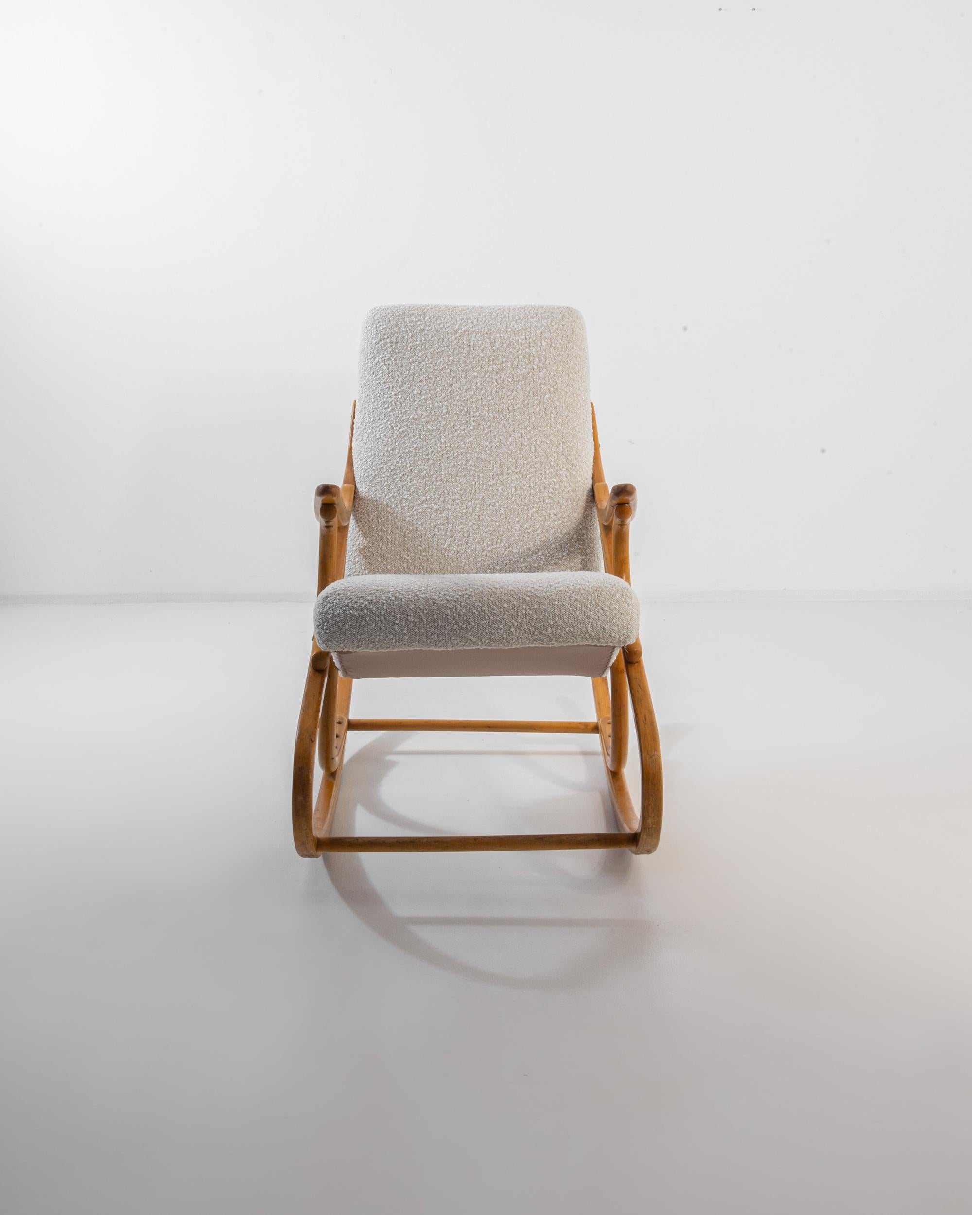 This vintage wooden chair was produced in Czechia, circa 1960. A rocking chair in bentwood, this classic piece was crafted by TON, a furniture company famous in Europe for their steamed wood technique and hand crafted quality since 1861. Bringing