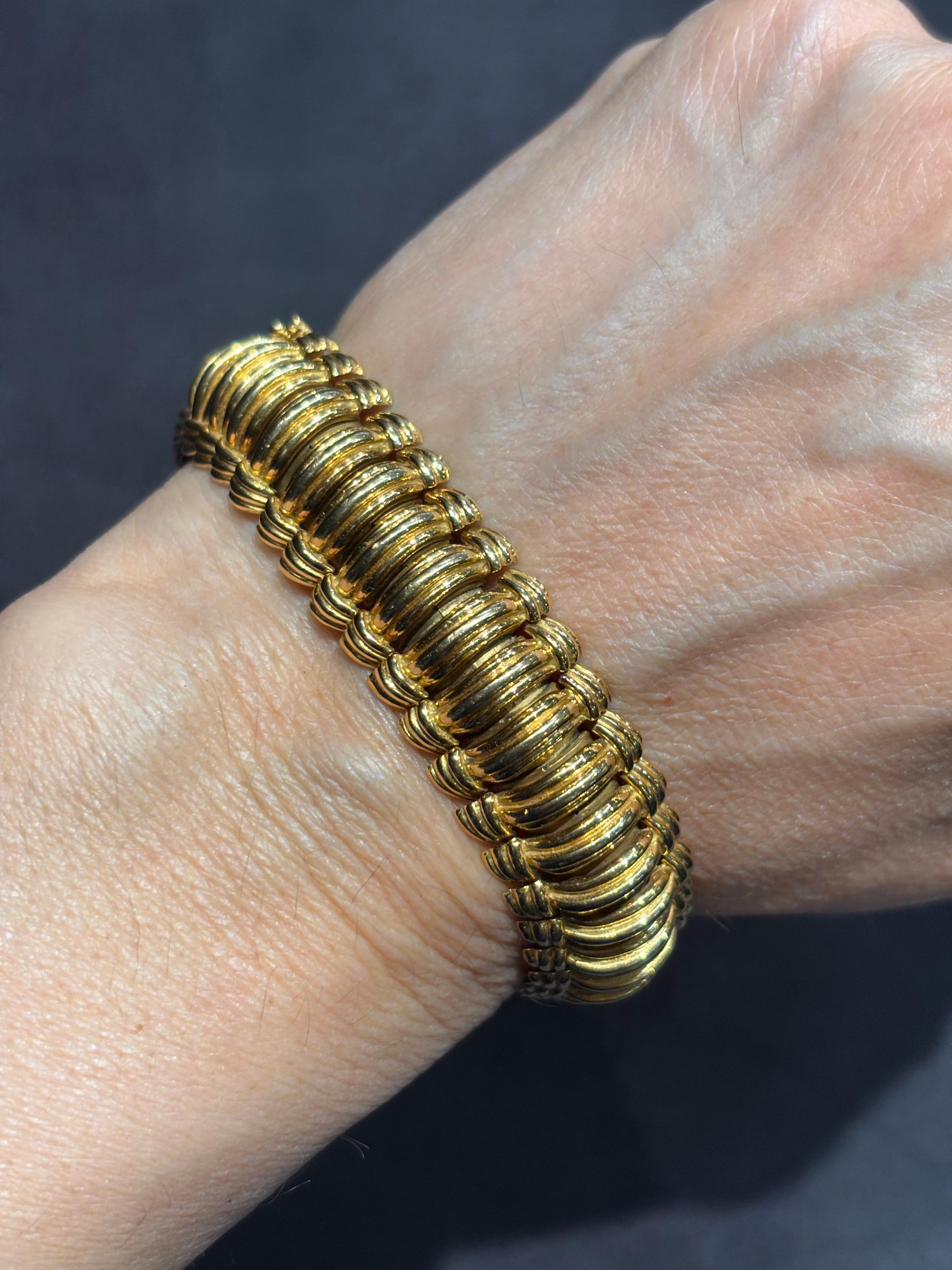Dieses aufwändig gefertigte Armband aus 18 Karat Gold ist ein Beweis für die hohe Kunstfertigkeit von Van Cleef & Arpels. Obwohl es recht klobig aussieht, besteht es aus kleinen, miteinander verbundenen Teilen, die das Armband völlig flexibel