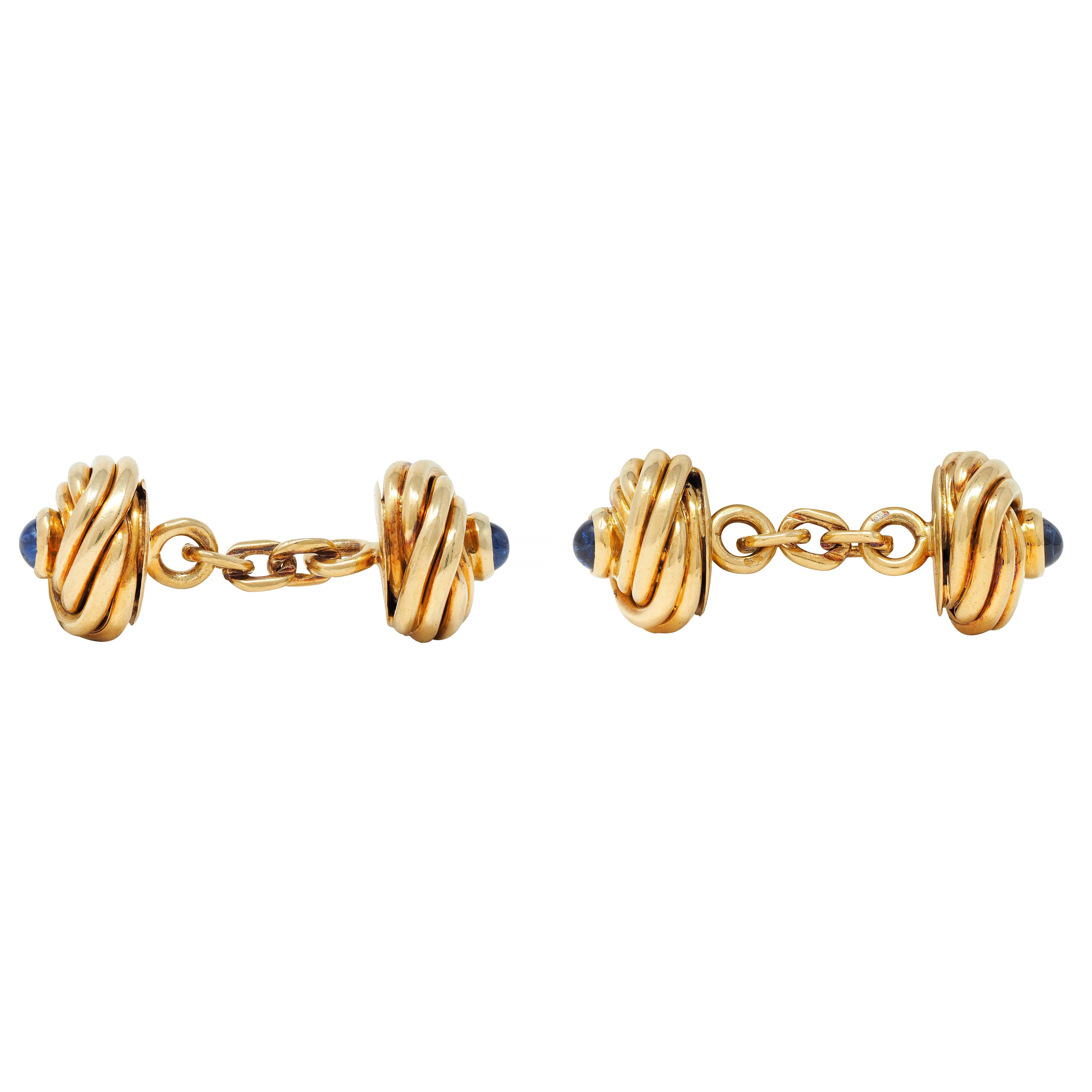 Link style cufflinks terminate with matching round twisted knot motifs
Deeply grooved and centering bezel set sapphire cabochons
Weighing approximately 1.32 carats total
Transparent medium blue in color
Completed by high polish finish
Stamped with
