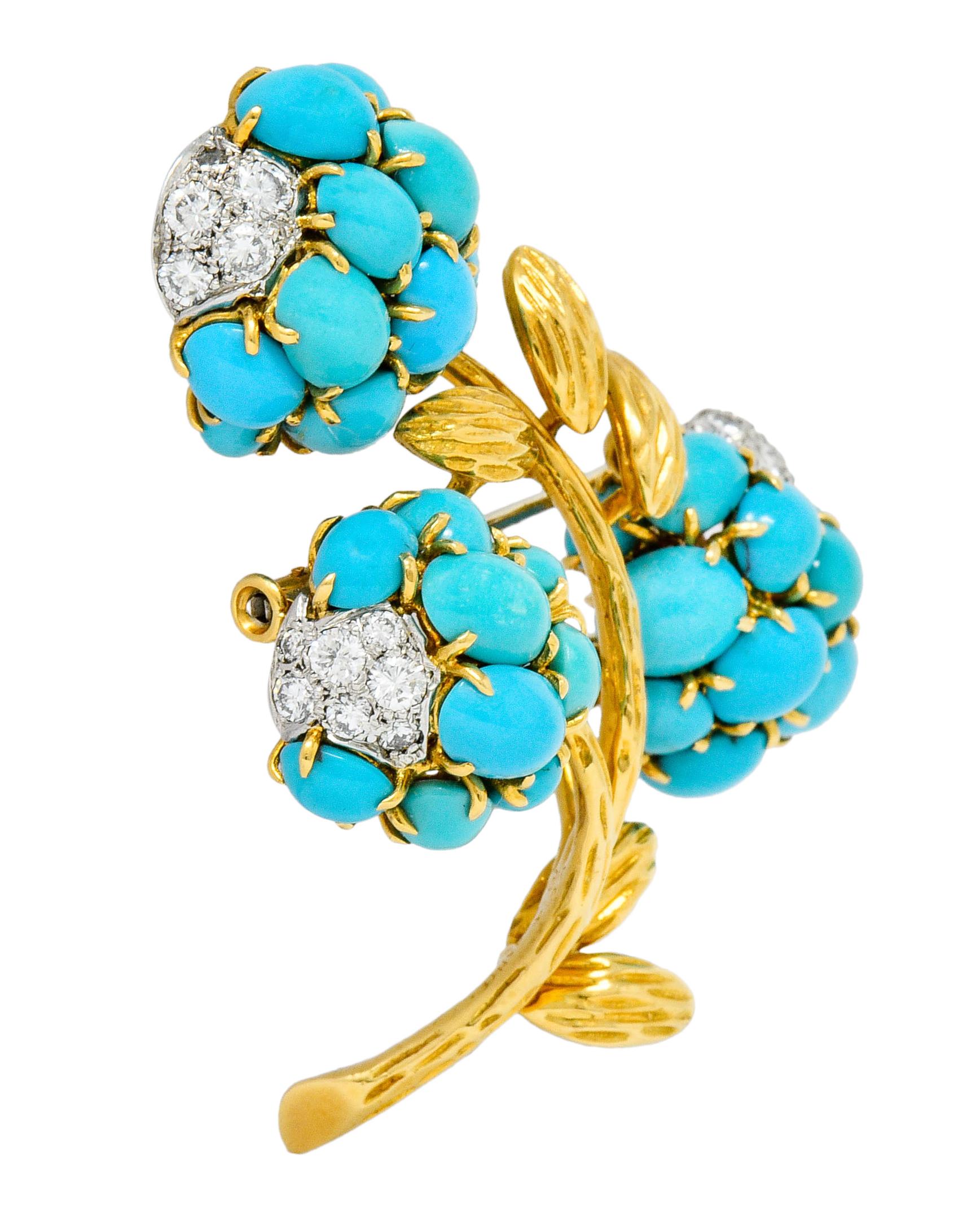 Brooch is designed as three clustered flowers blooming from a very textured gold stem

Each flower is comprised of claw set round and oval turquoise cabochon, opaque, and greenish-blue to robin's egg blue in color

Accented by platinum pavè fields