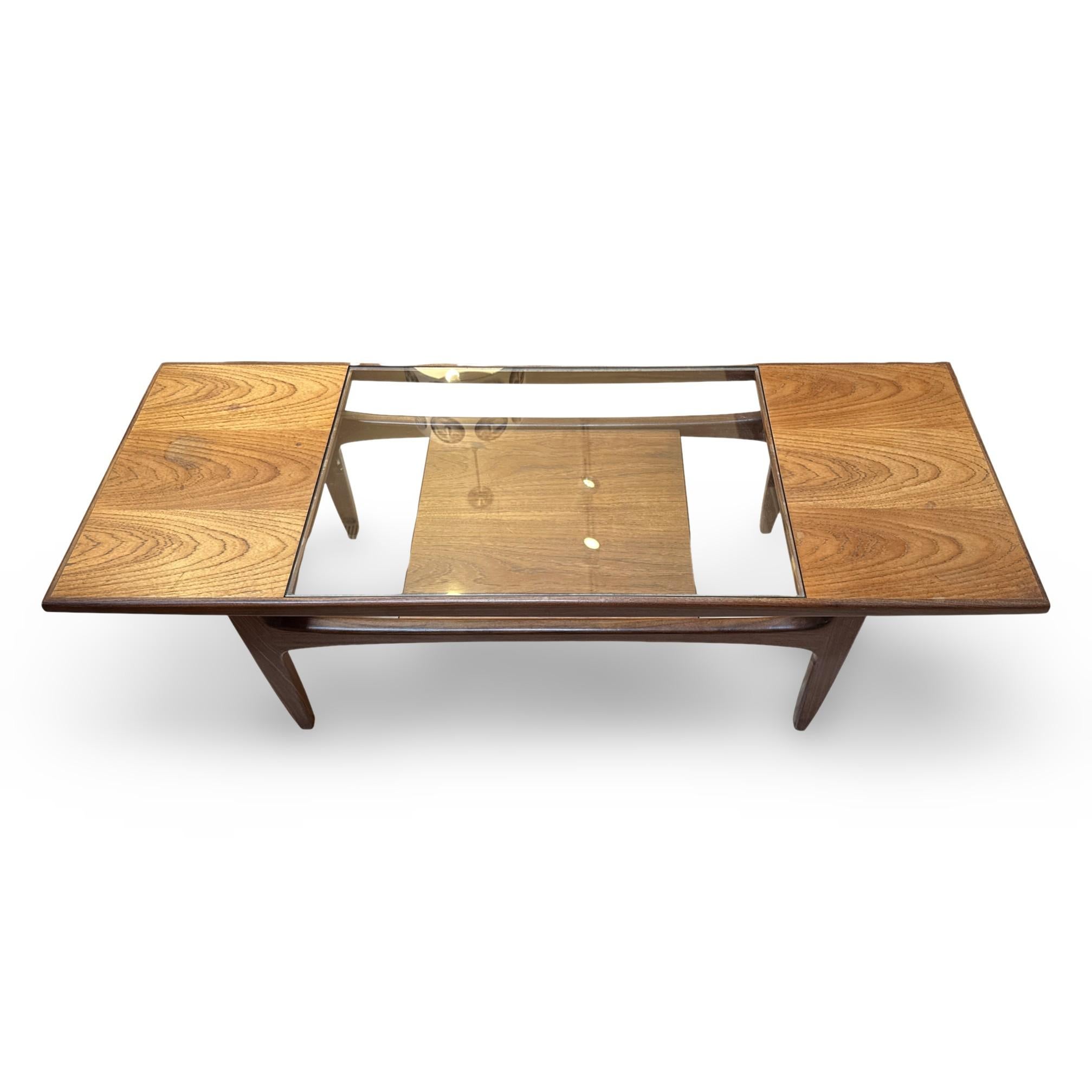 1960s mid-century modern teak and glass coffee table, designed by VB Wilkins for G-Plan, United Kingdom. The table has a removable glass insert and a lower storage shelf. In good vintage condition, with some light water marks, as shown in photo. A