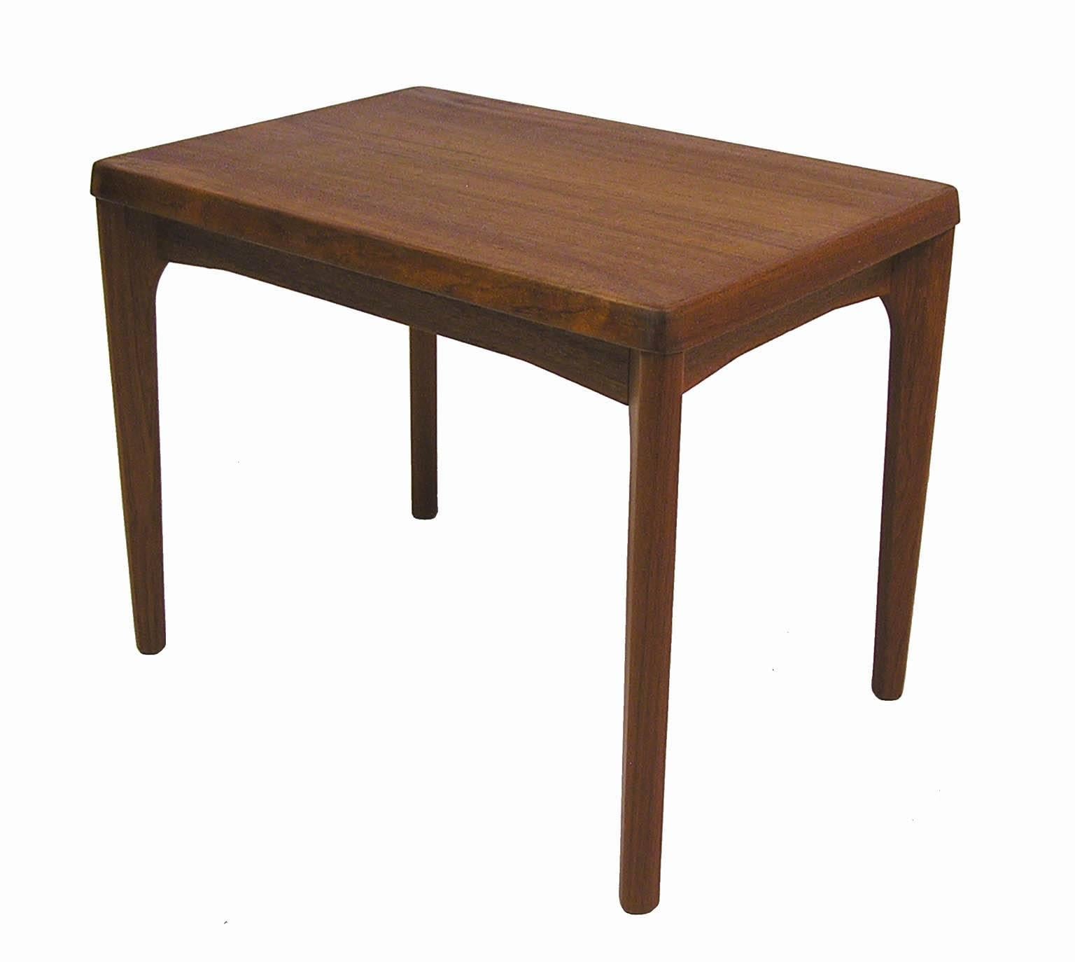 A gorgeous pair of teak side tables from the 1960s designed by Henning Kjaernulf for Vejle Stole Mobelfabrik of Denmark. Quality craftsmanship throughout featuring clean Danish modern era lines with a sculpted solid teak edge and legs. Overall