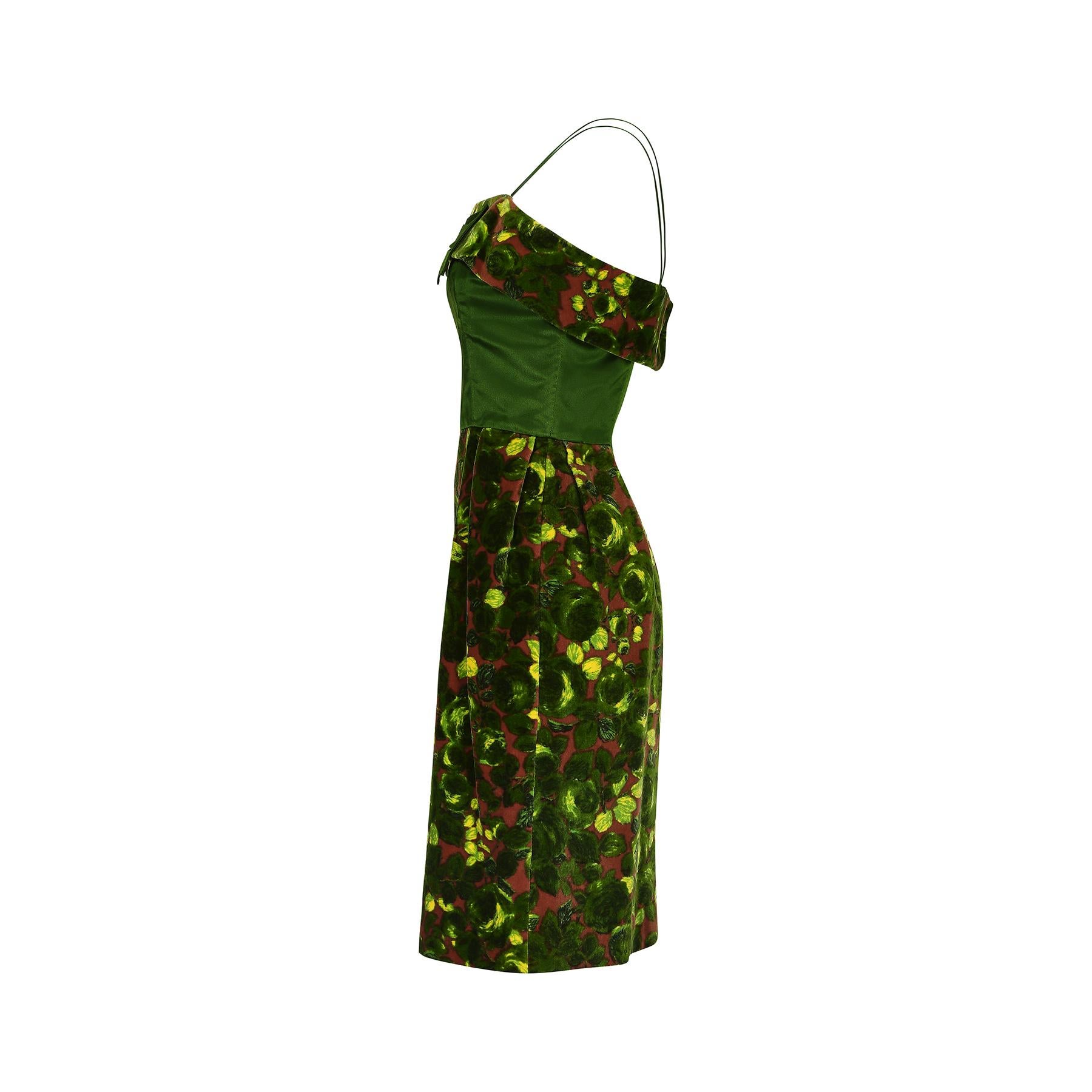 An unusual combination of forest greens, yellow and rich russet red feature in this early 1960s rose print cocktail dress.  Both the pencil skirt and the trim of the square neckline are made from a cotton blend velvet which is contrasted with a