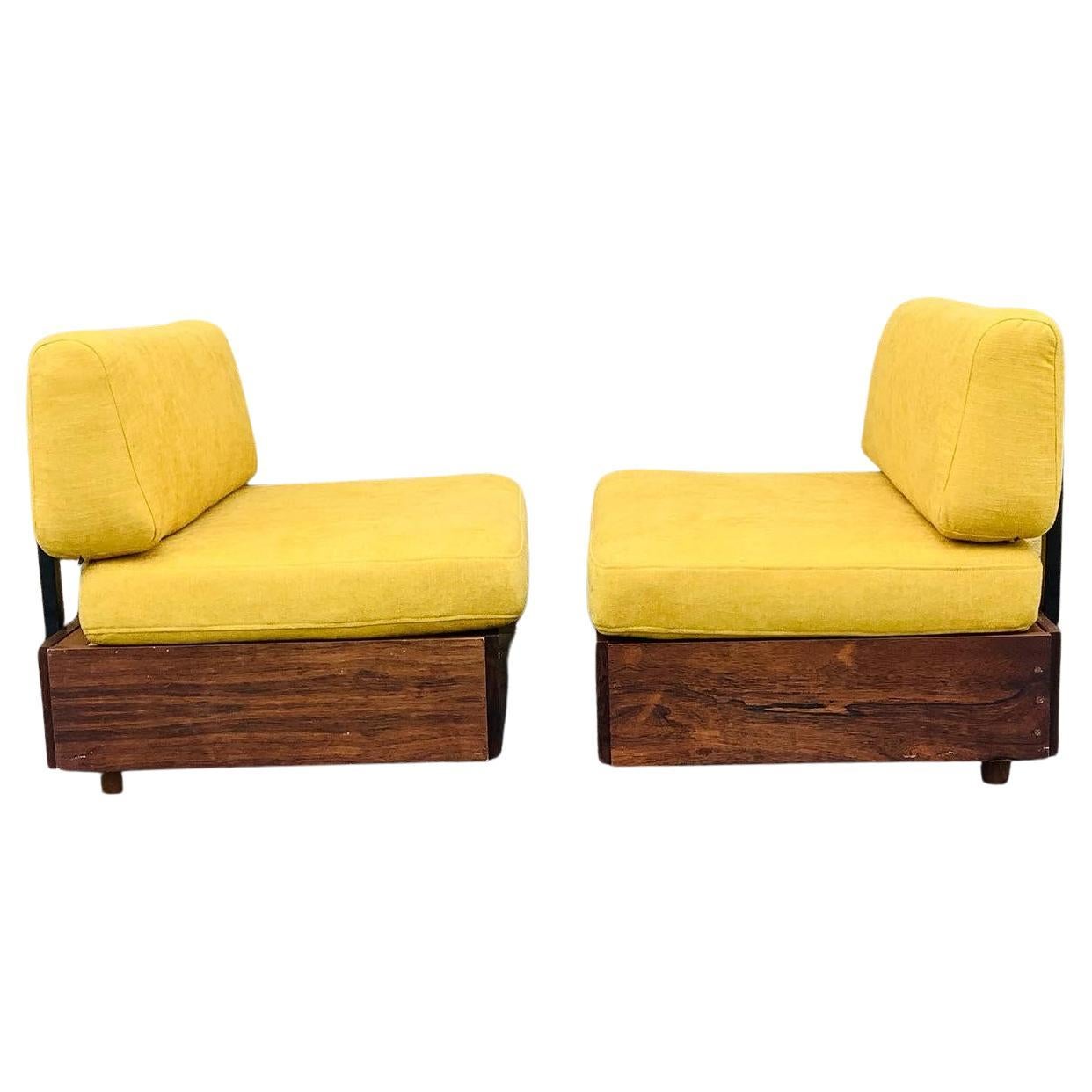 Two early Verner Panton ‘Studioline’ sofa /daybed modules designed in 1961 and produced by France & Søn. Wooden frame with legs in front and wheels behind. Cushions in yellow cotton fabric. Storage under the seating. L. 100 D. 67 cm. Has a little