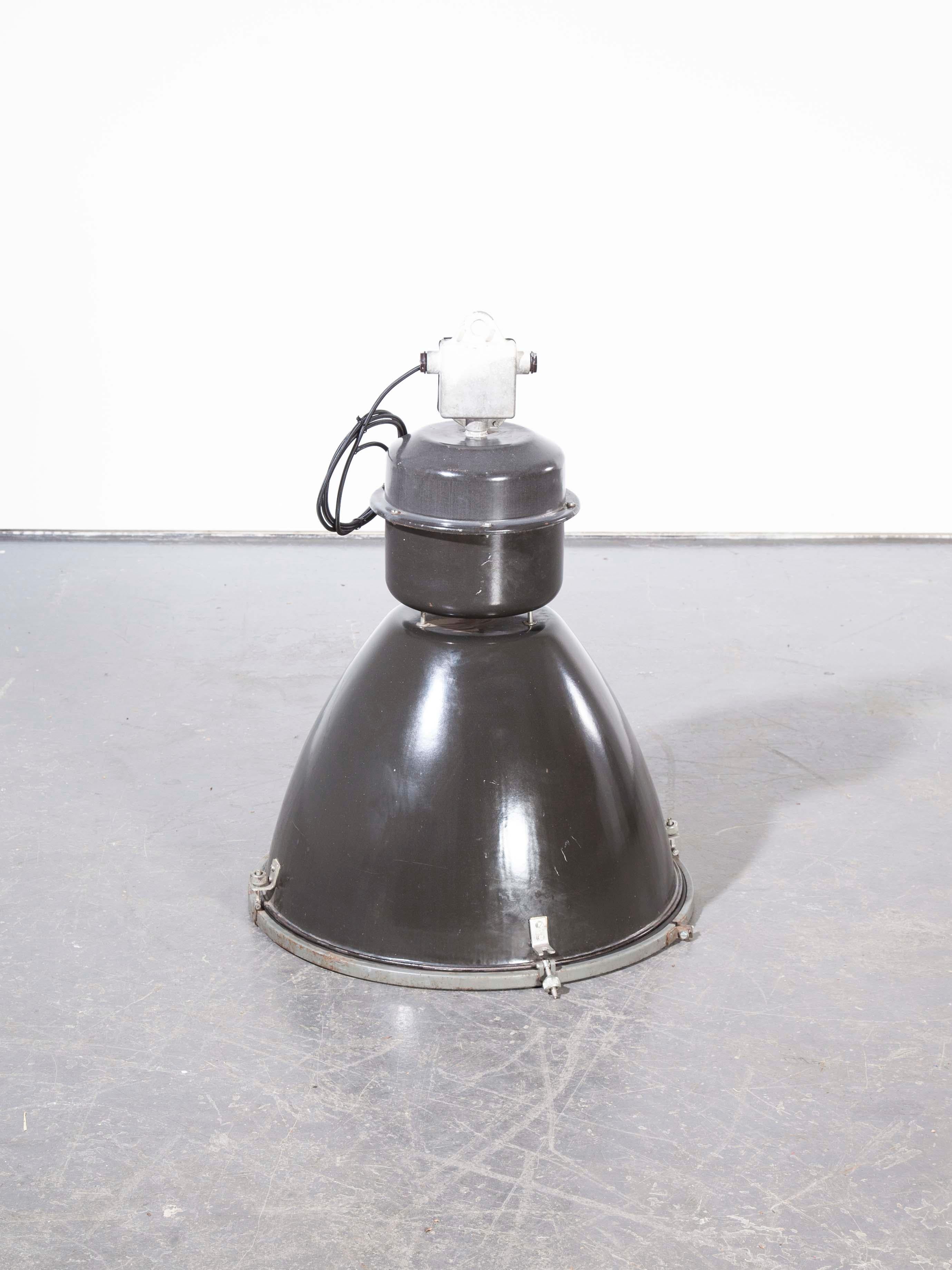 1960s very large industrial black enamel ceiling pendant lamps/light shades. A mainstay of many eastern European factories these lamps feature large scale enamelled steel shades and cast metal tops. The key feature of these lamps is their stunning